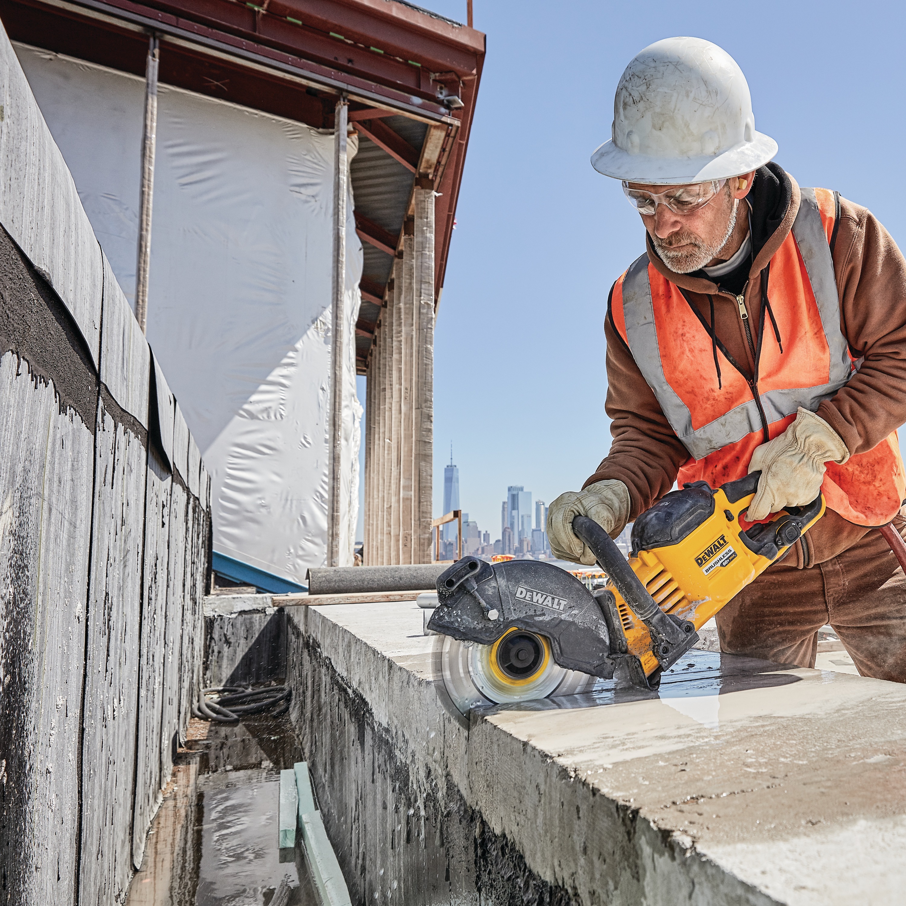 20 Volt to 60 Volt 12 AMP hours Lithium Ion Battery powered Circular Saw being used by a construction worker to cut concrete at a construction site