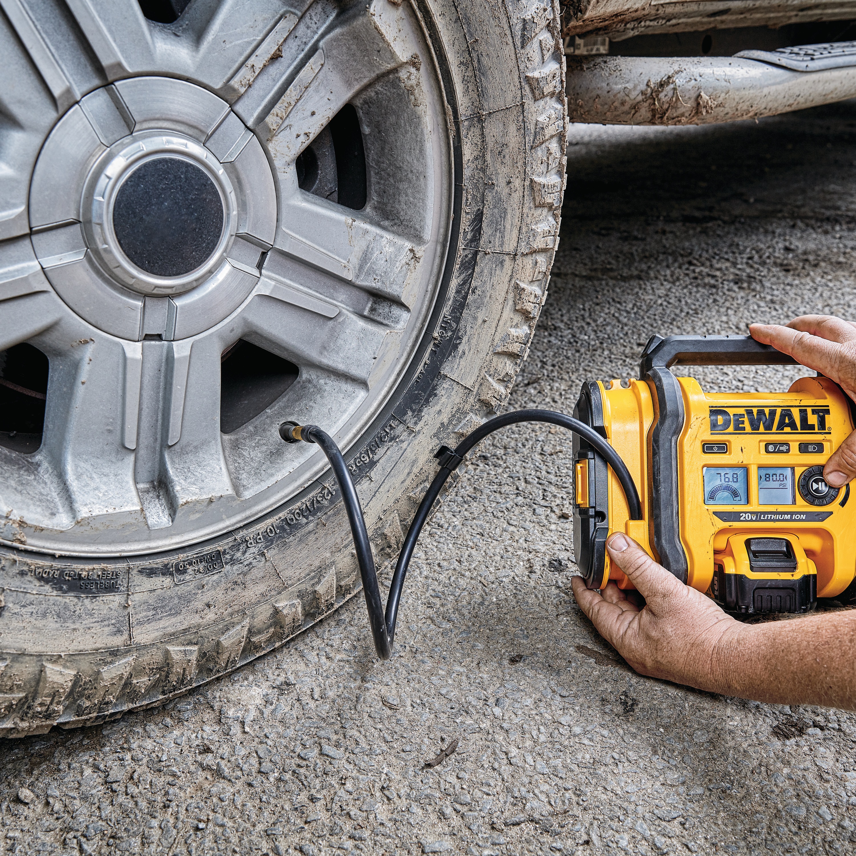 Corded/Cordless Air Inflator being used by a person to inflate a tire