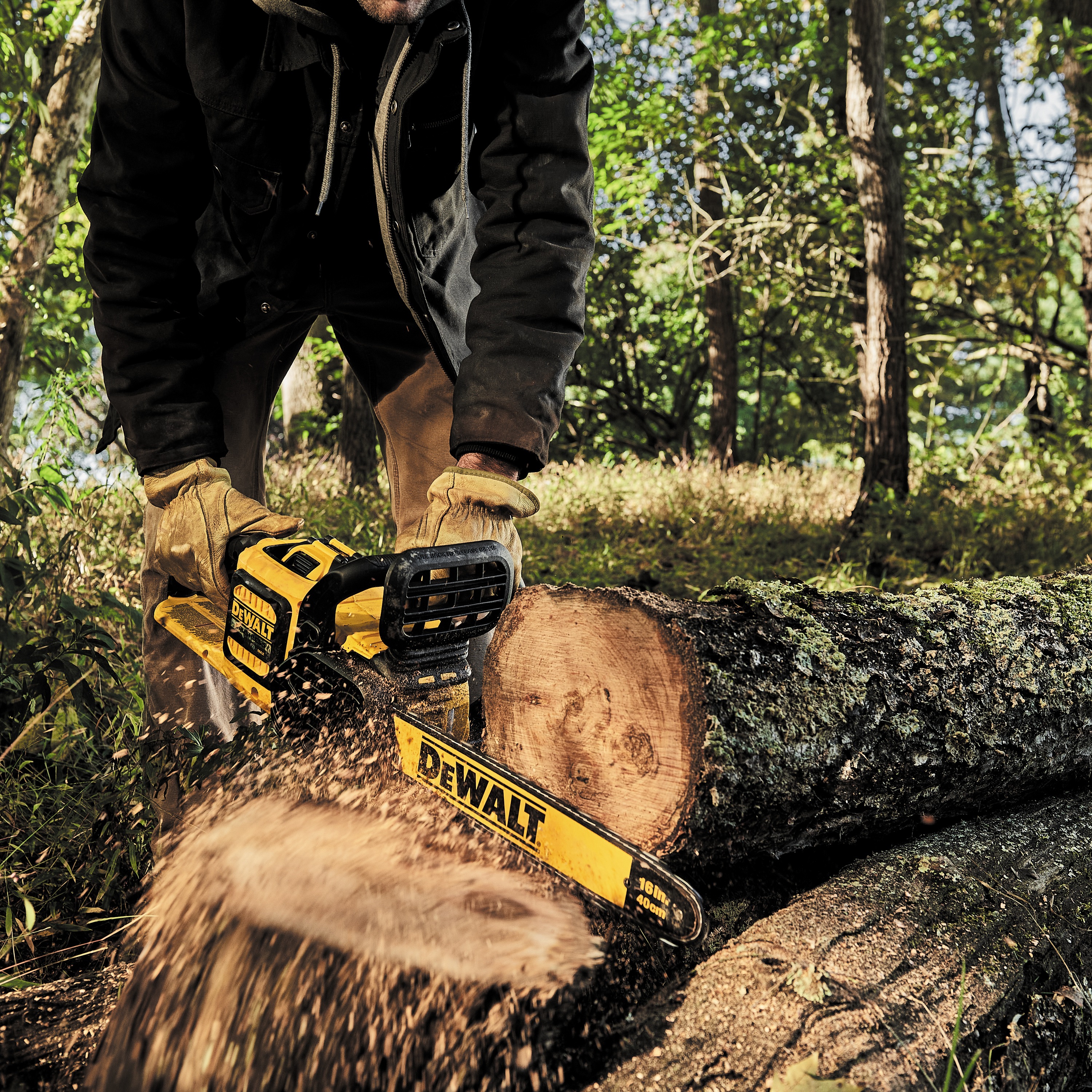 FLEXVOLT Cordless Chainsaw being used by a worker to cut a thick wood log in a forest