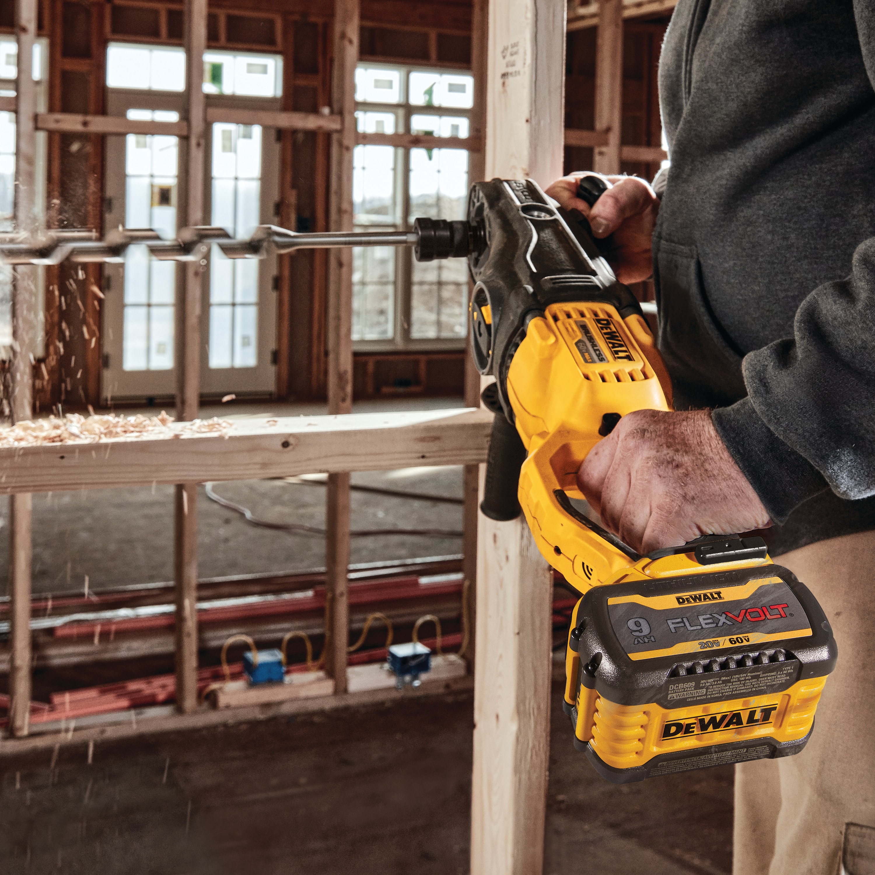 Brushless cordless quick-change stud and joist drill drilling  wood.
