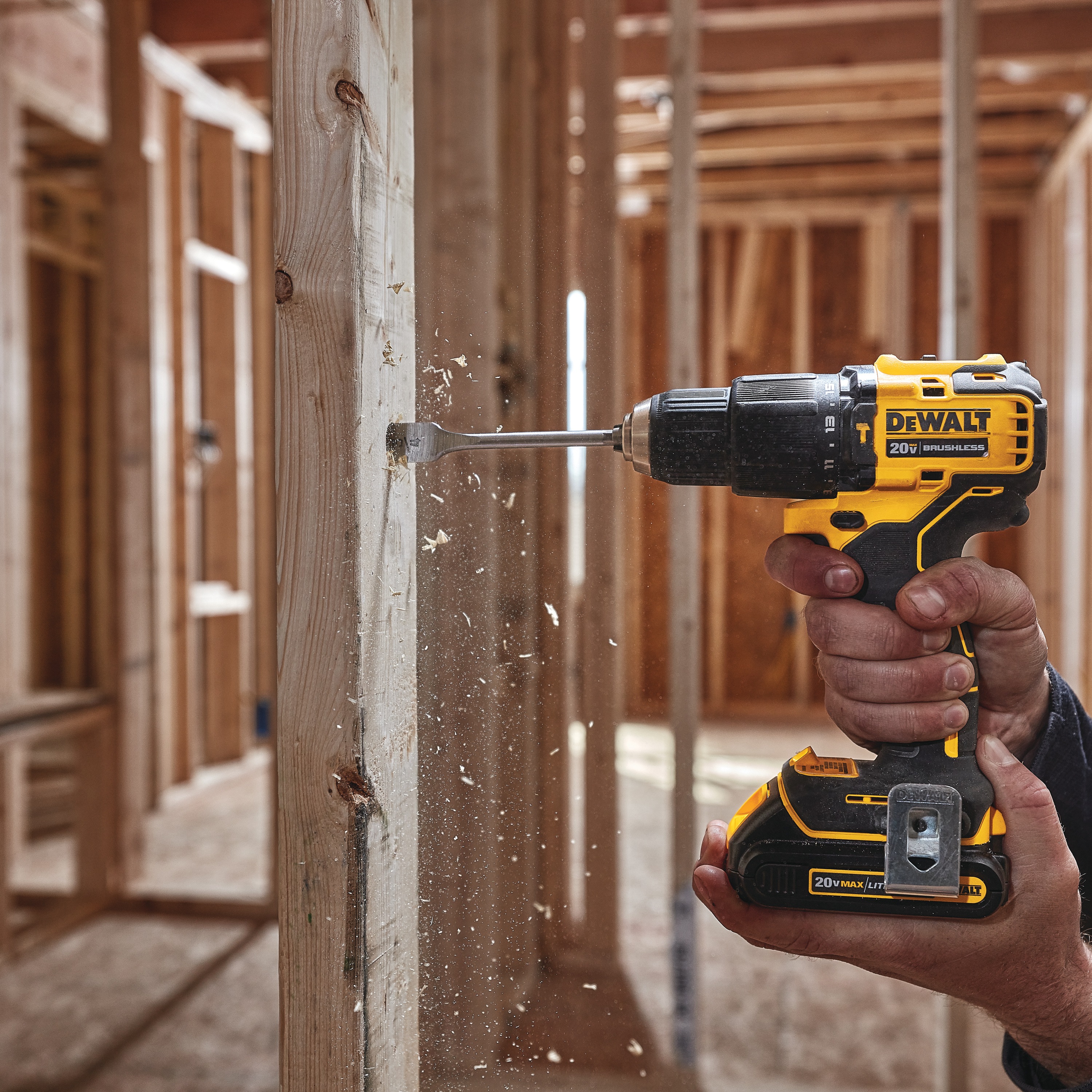 Atomic cordless compact half inch hammer drill driver drilling  wooden plank.
