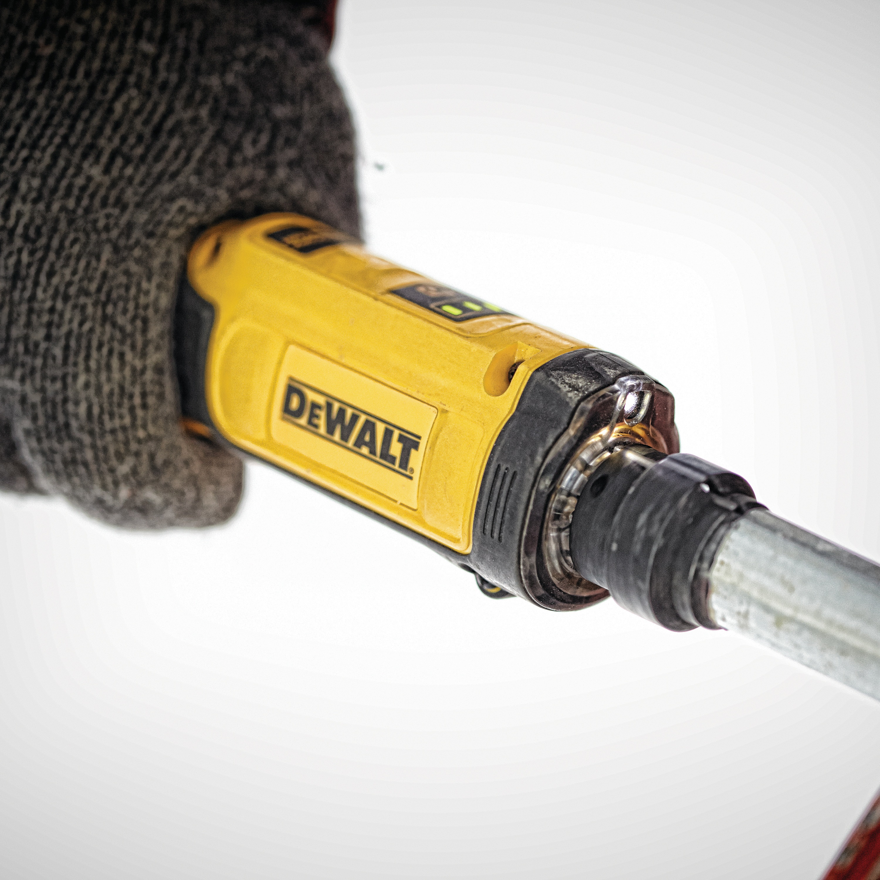 Gyroscopic screwdriver with conduit reamer being used on a pipe.