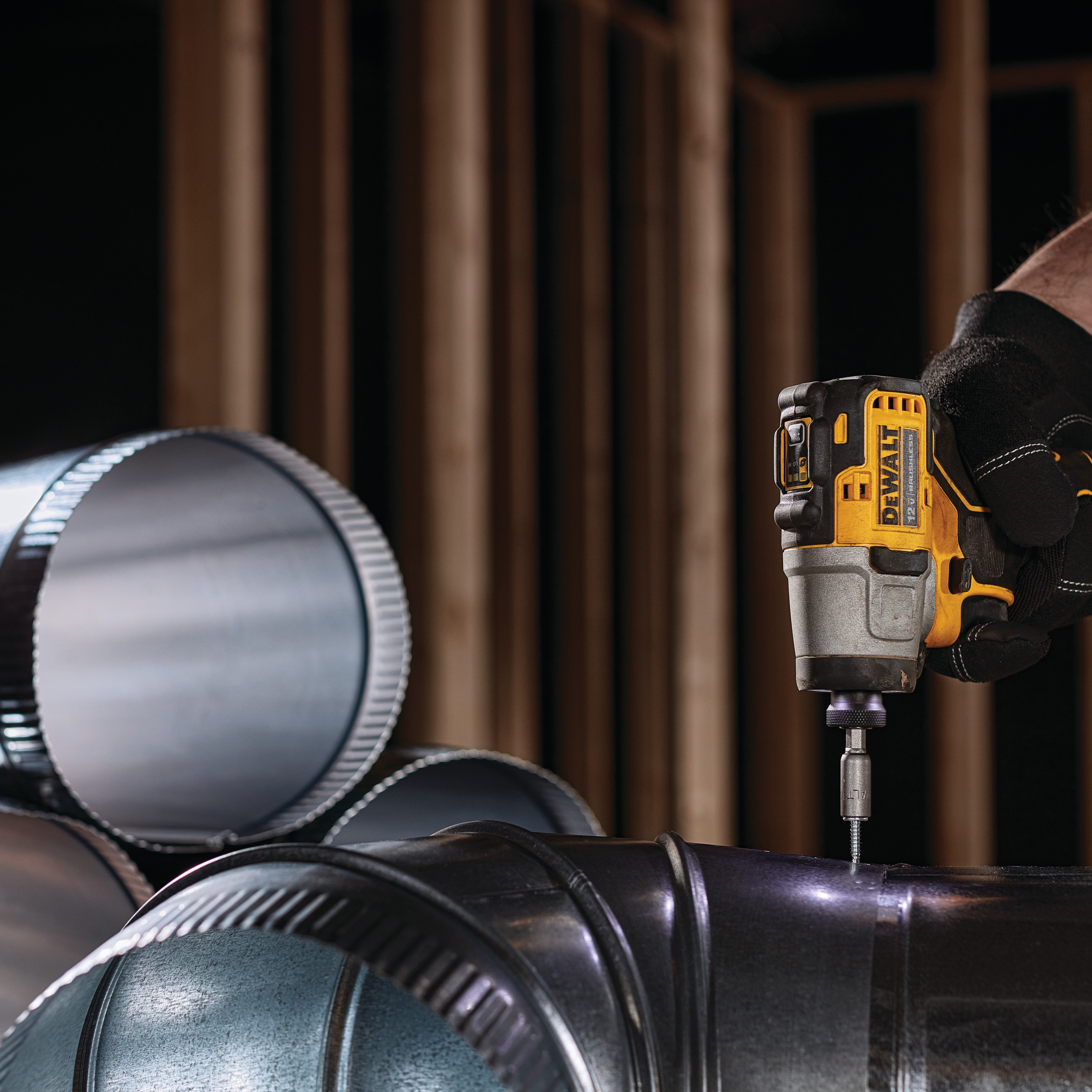 XTREME Brushless cordless impact driver fastening screw in ventilation pipe.