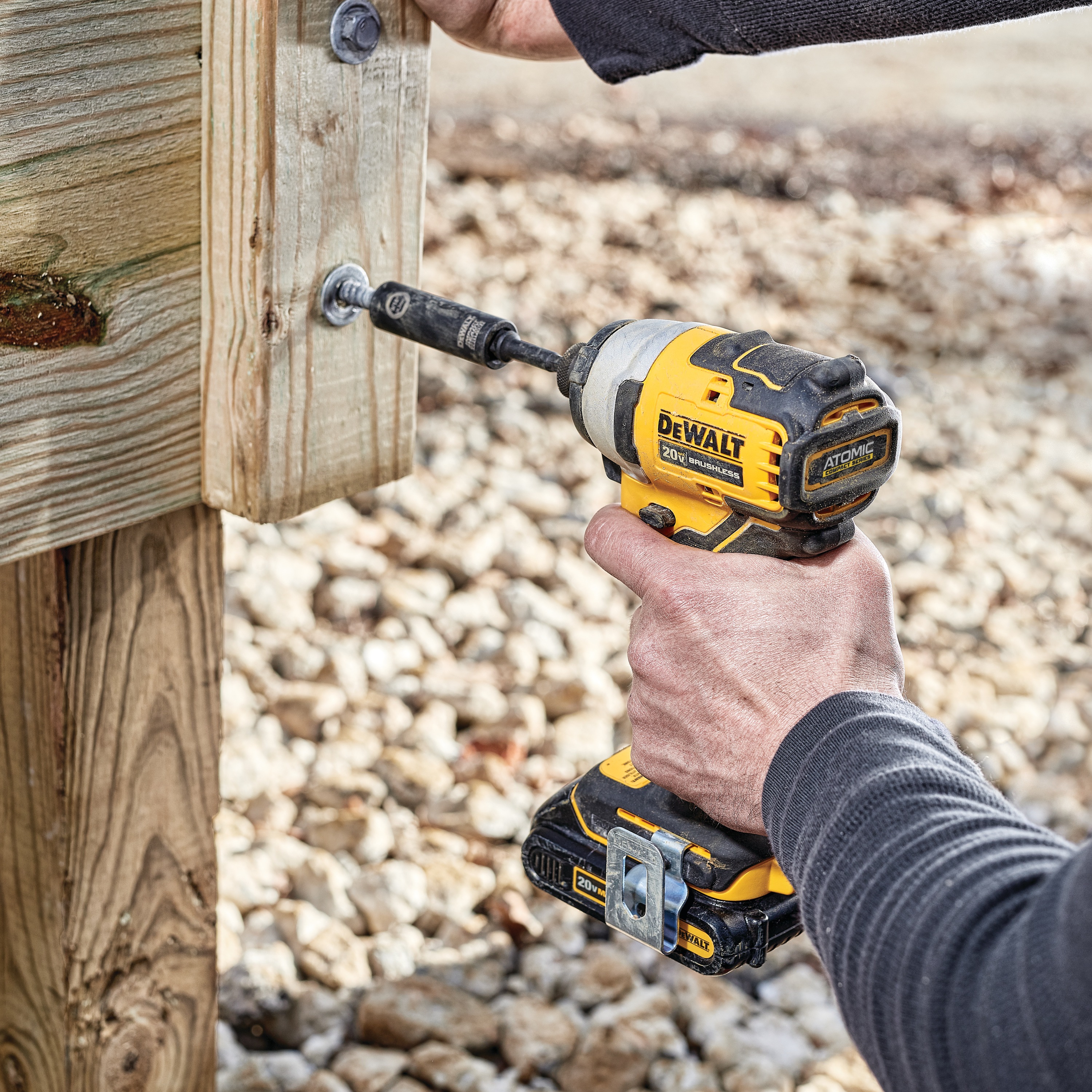 ATOMIC brushless cordless compact impact driver kit two battery kit fastening bolt on wood.