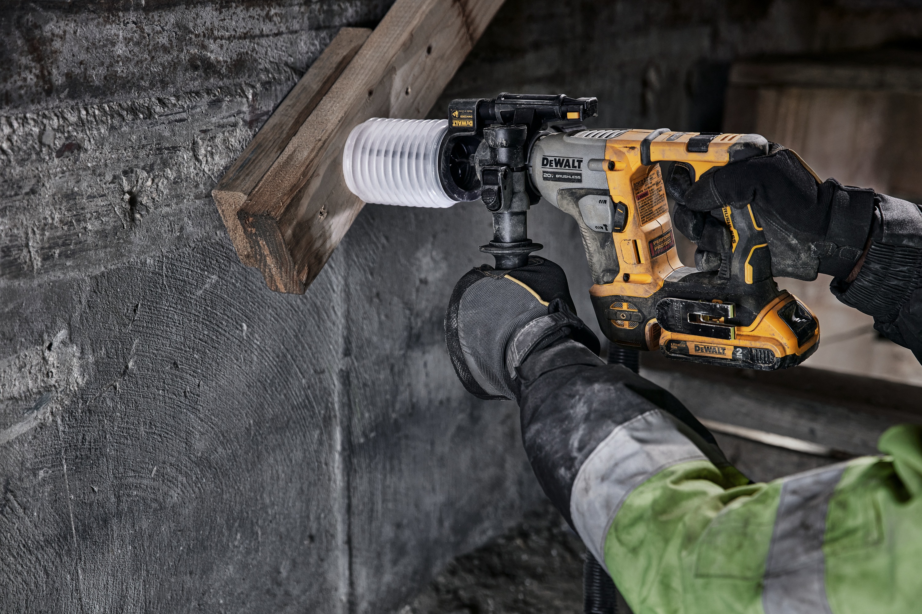 Atomic 20 volt five eighths inch brushless cordless S D S plus rotary hammer kit being used to hammer wood.