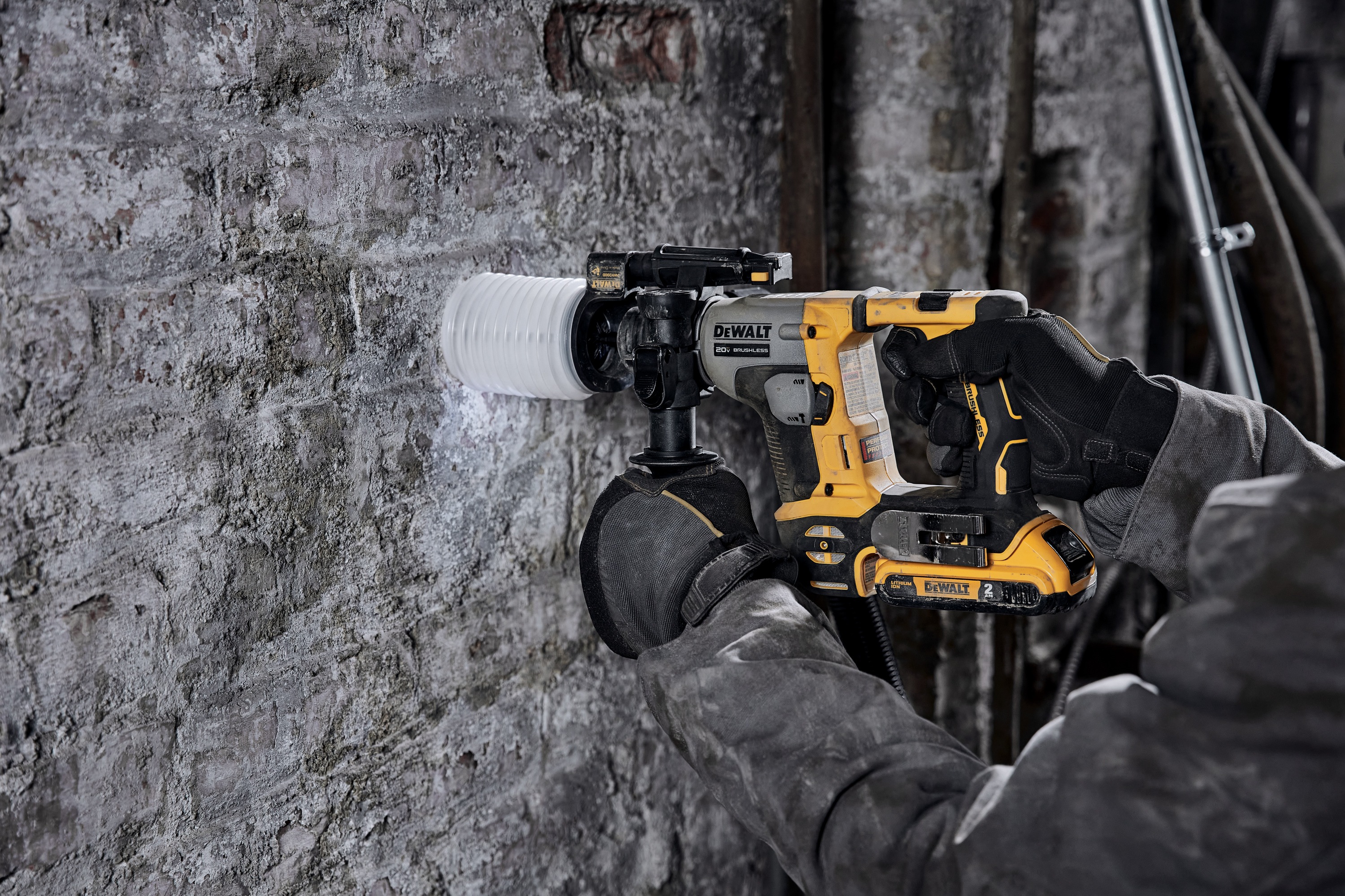Atomic 20 volt five eighths inch brushless cordless S D S plus rotary hammer kit being used to hammer wall.