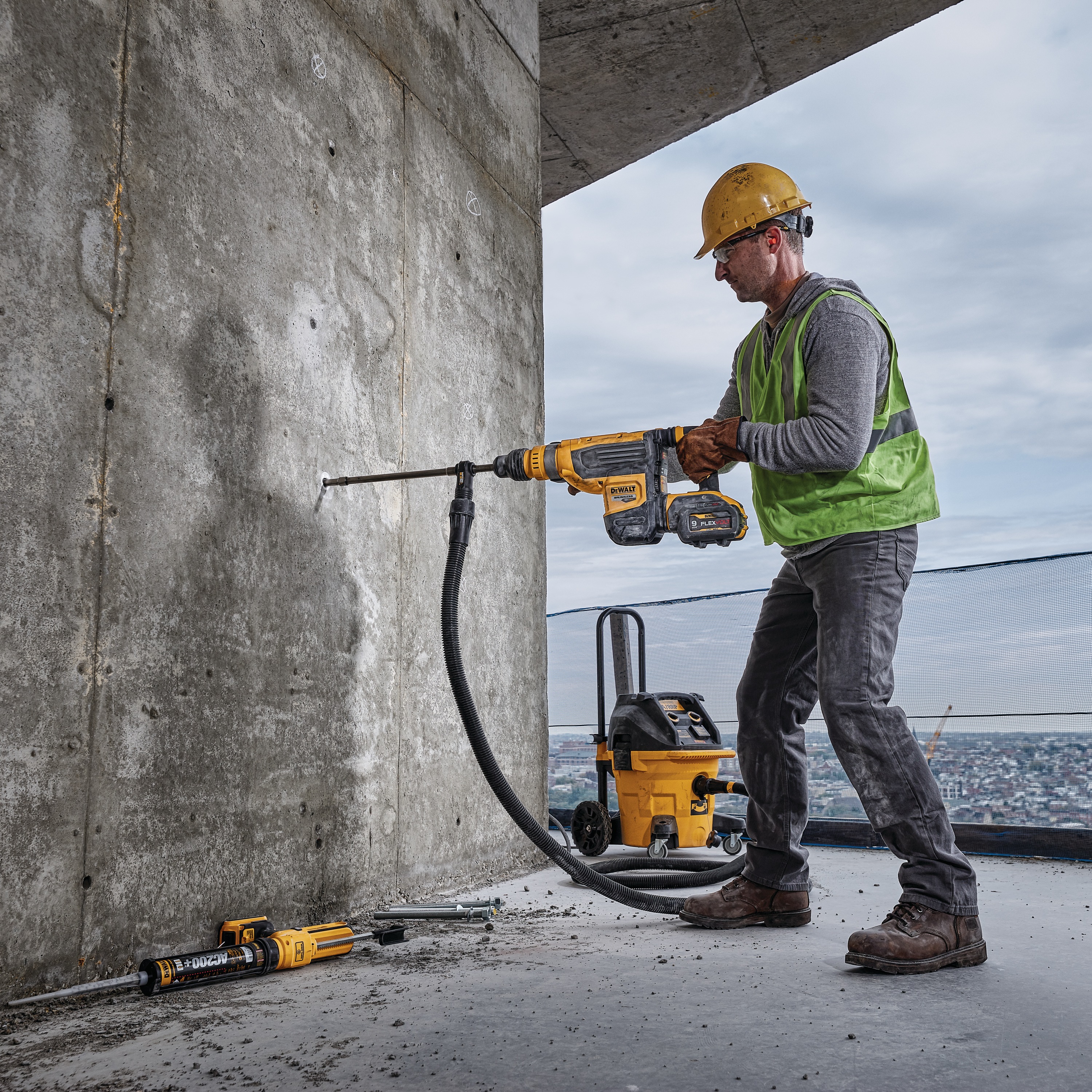 Brushless, cordless SDS MAX combination rotary hammer being used by a person at high rise construction site