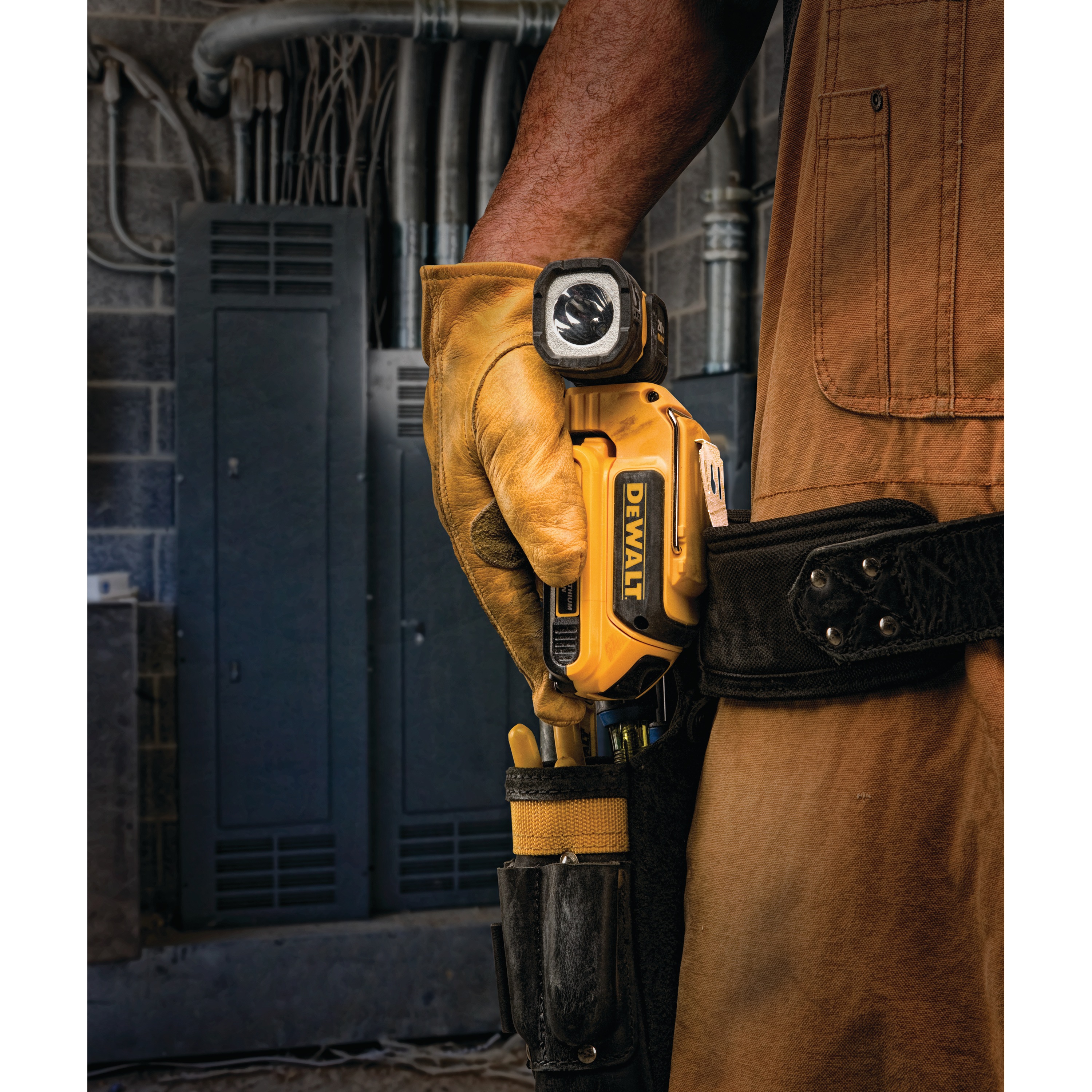 LED handheld work light being shown in a person's tool pouch