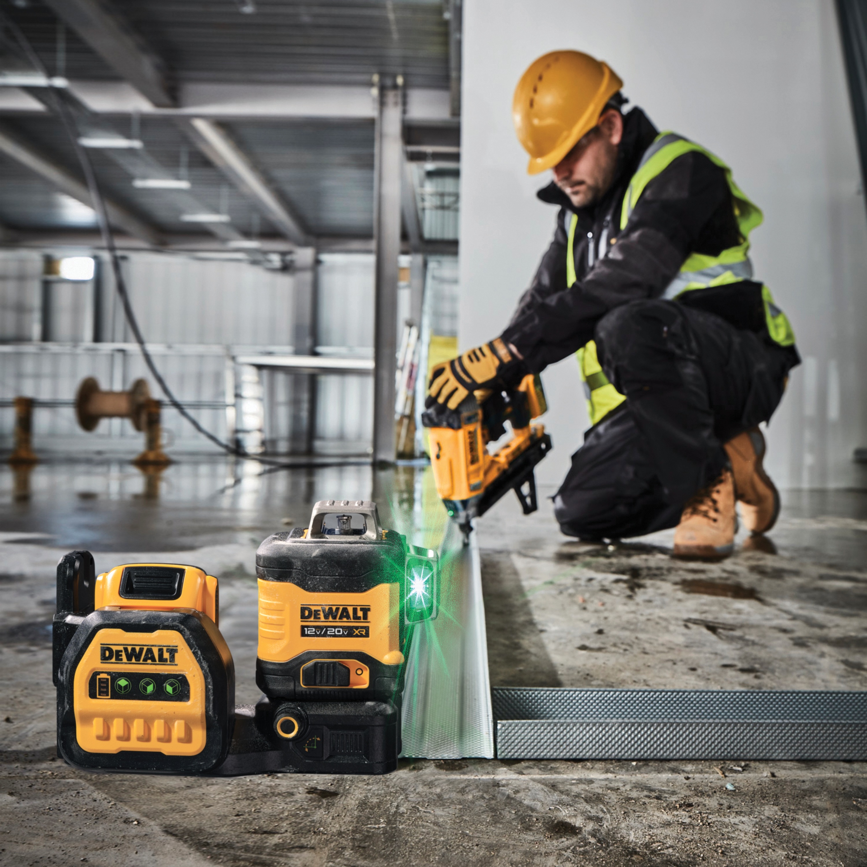 green line laser being used by a worker