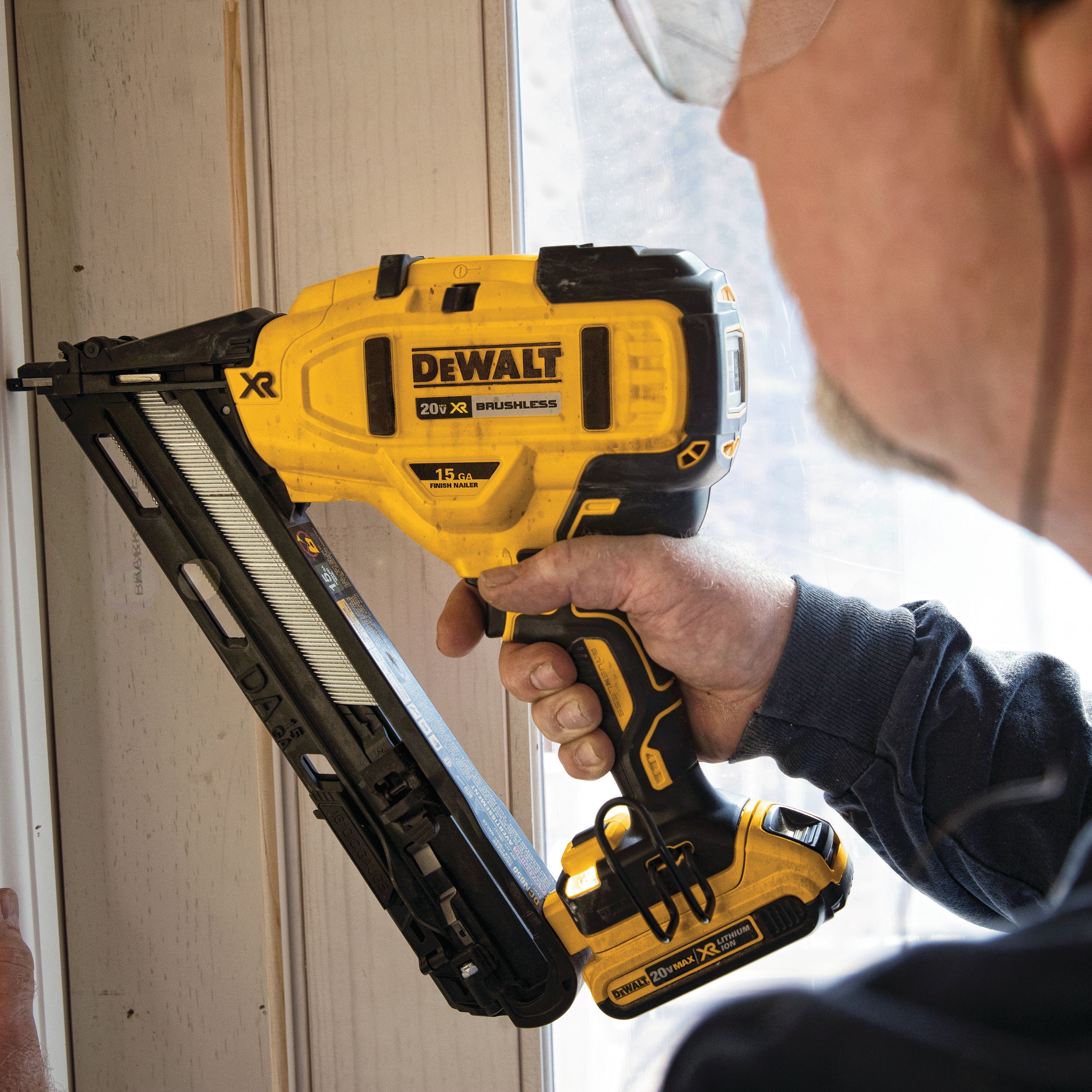 Cordless 15 Gauge Angled Finish Nailer in action on a wooden door frame