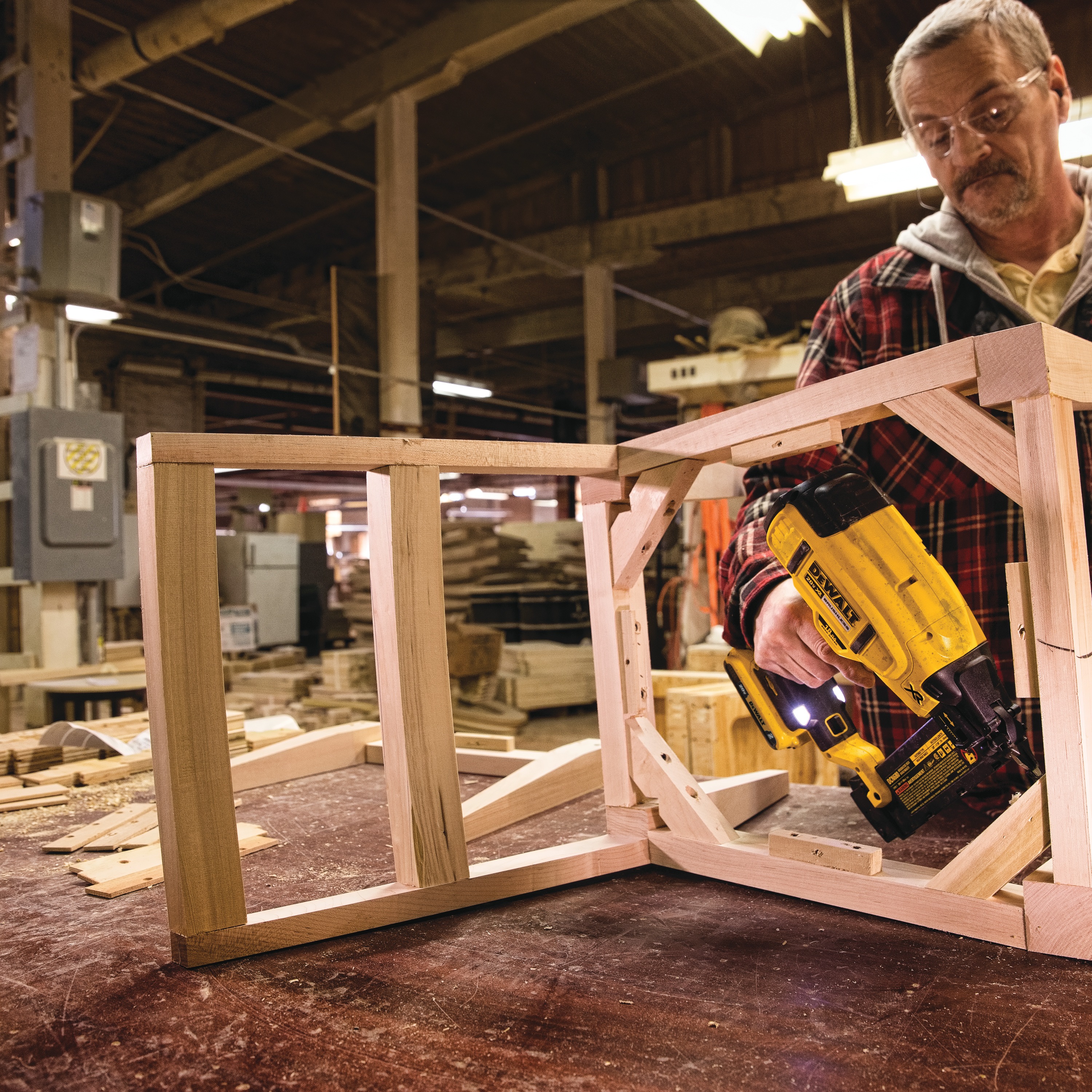 XR 18 gauge Cordless Brad Nailer in action on frame of a wooden chair by a construction worker