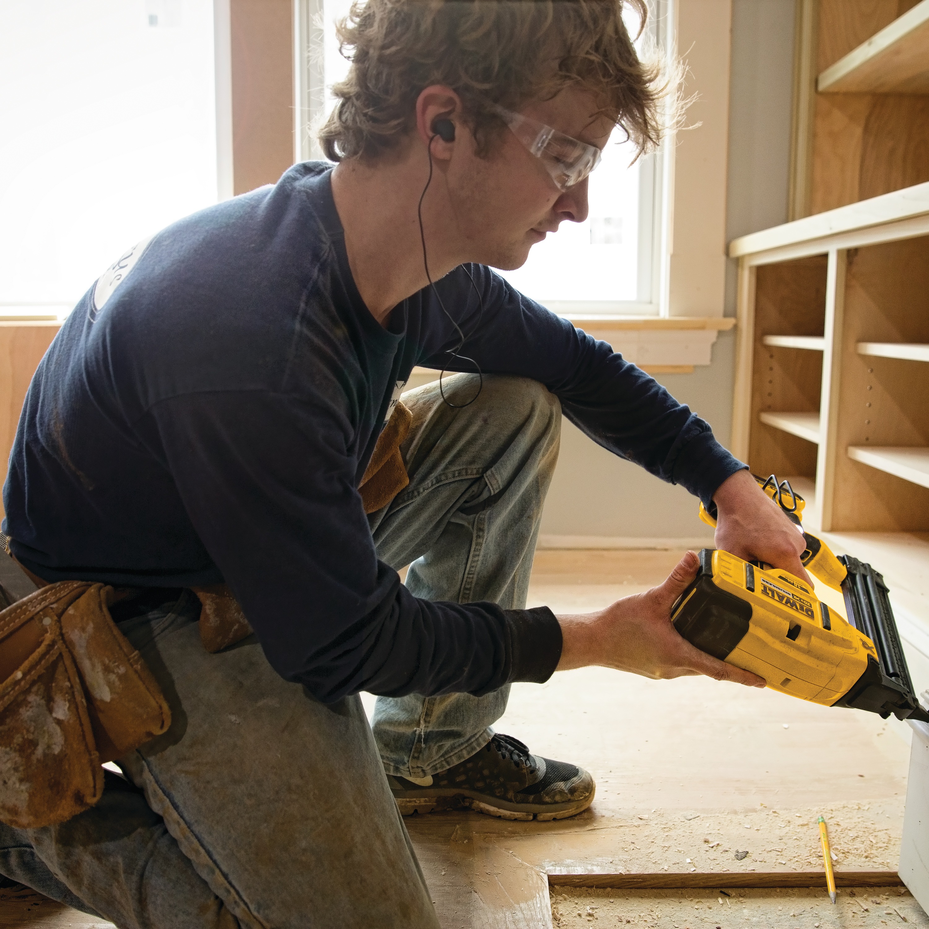 XR 18 gauge Cordless Brad Nailer in action by construction worker on a wooden cabinet at a construction site