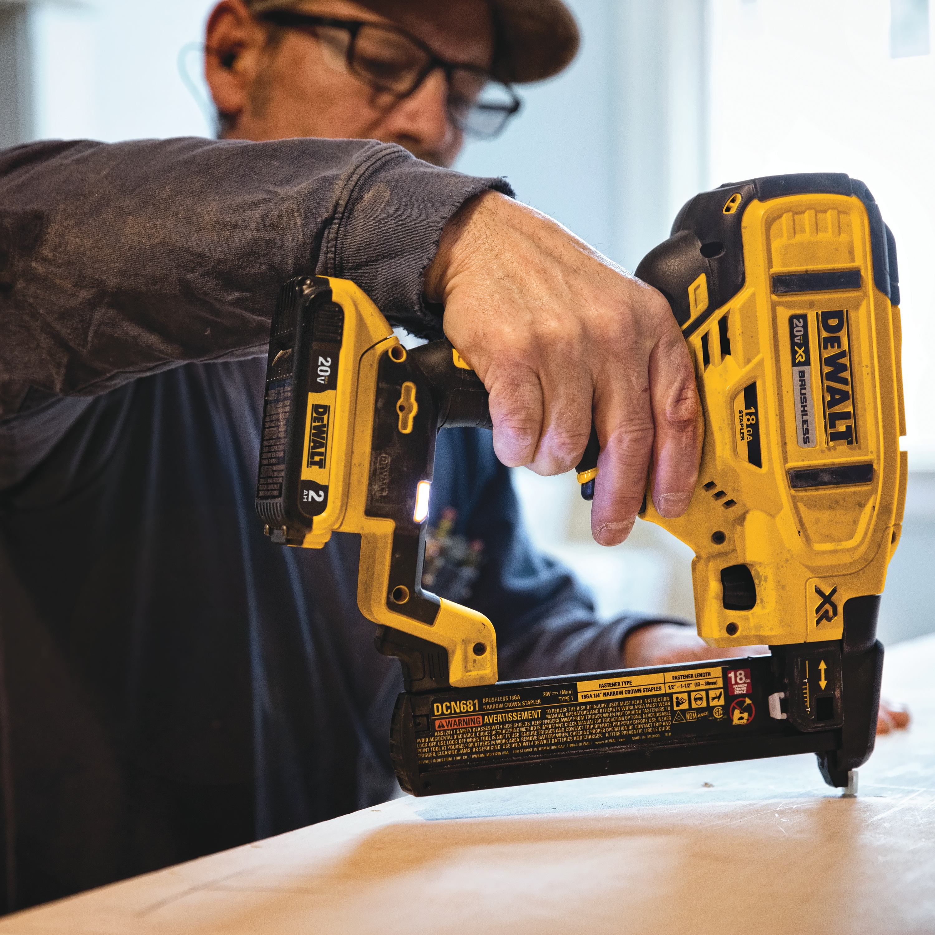 XR 18 gauge Cordless Narrow Crown Stapler in action on wooden board by a construction worker
