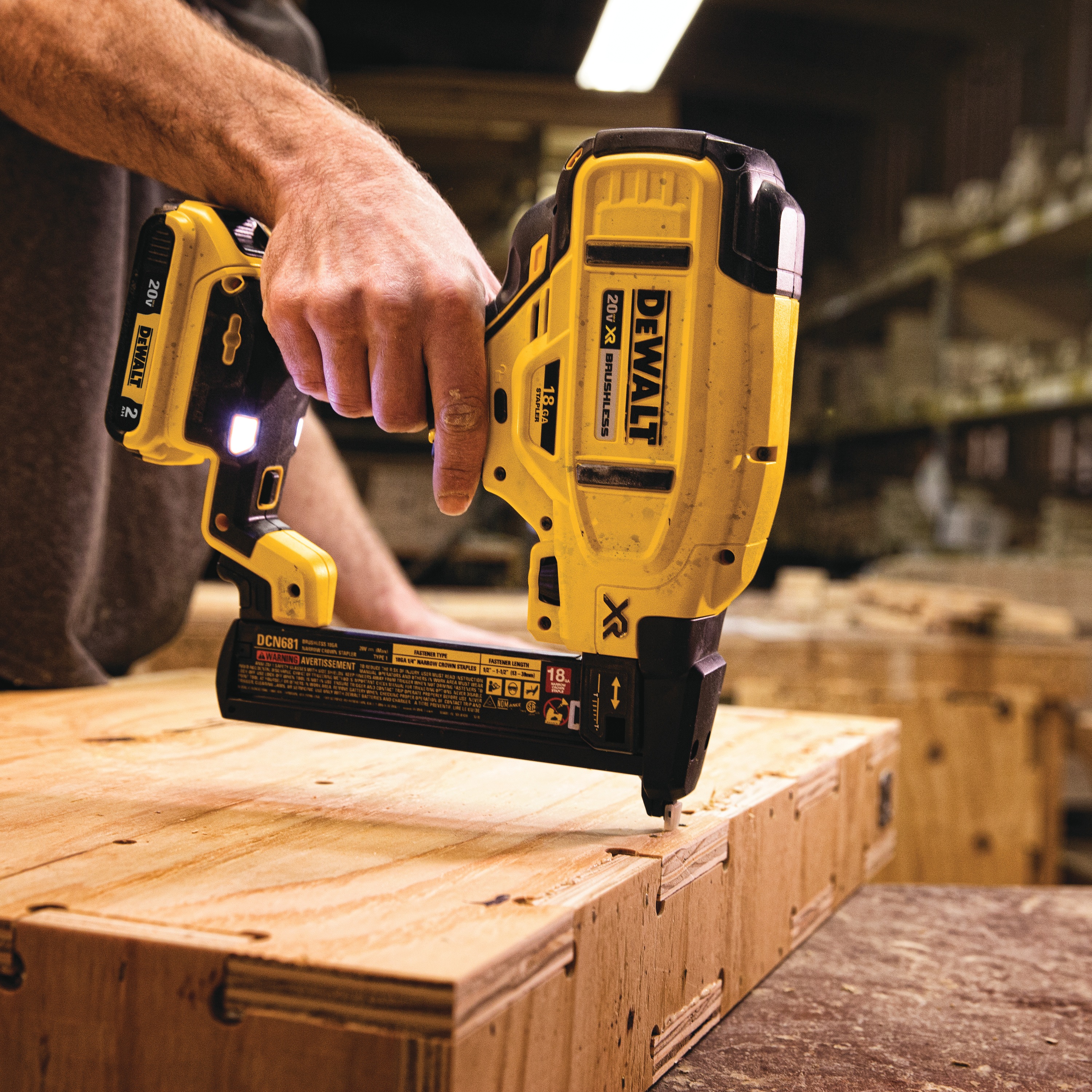 XR 18 gauge Cordless Narrow Crown Stapler in action on a wooden board at a construction site