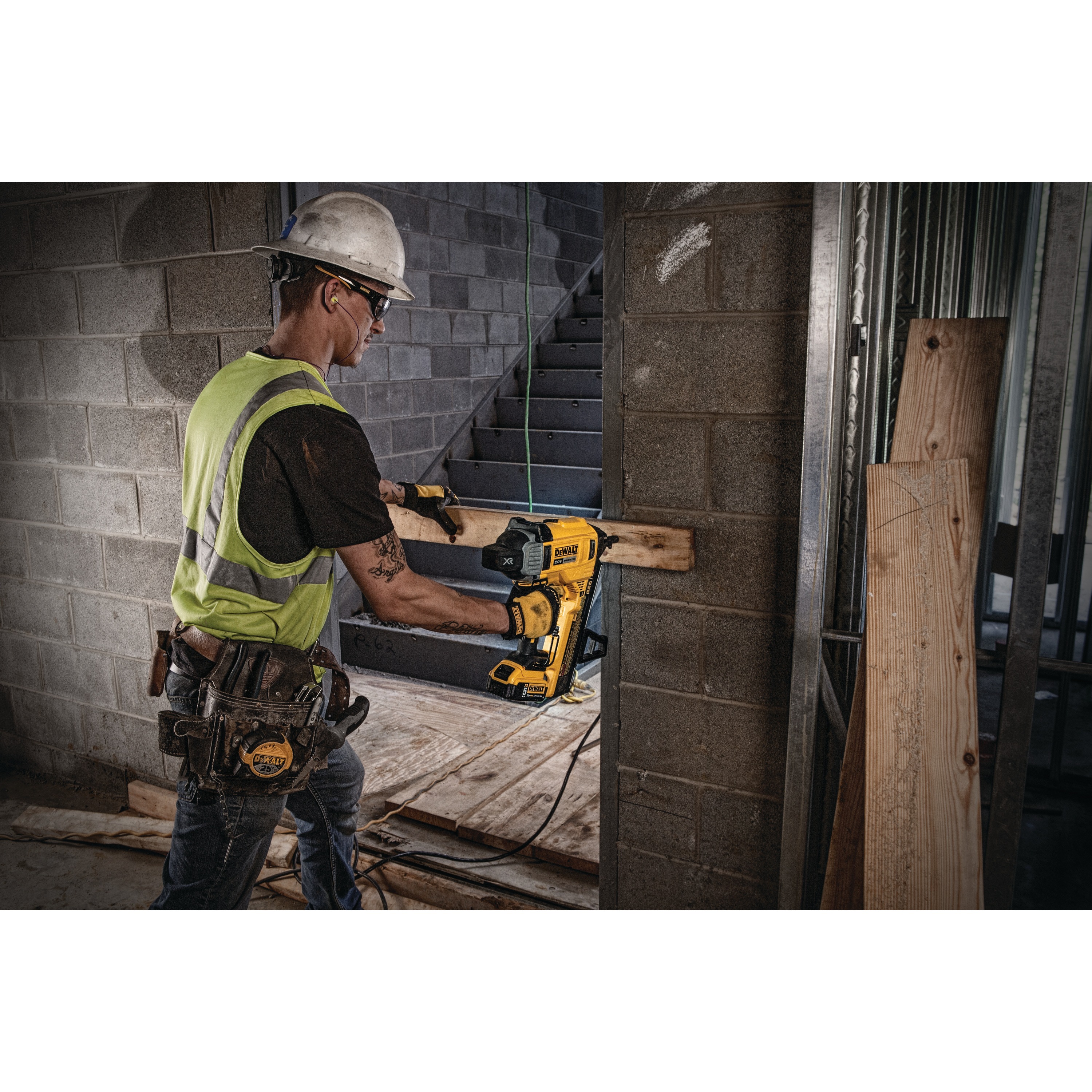 Cordless Concrete Nailer being used by a person to fasten nails into wooden plank.