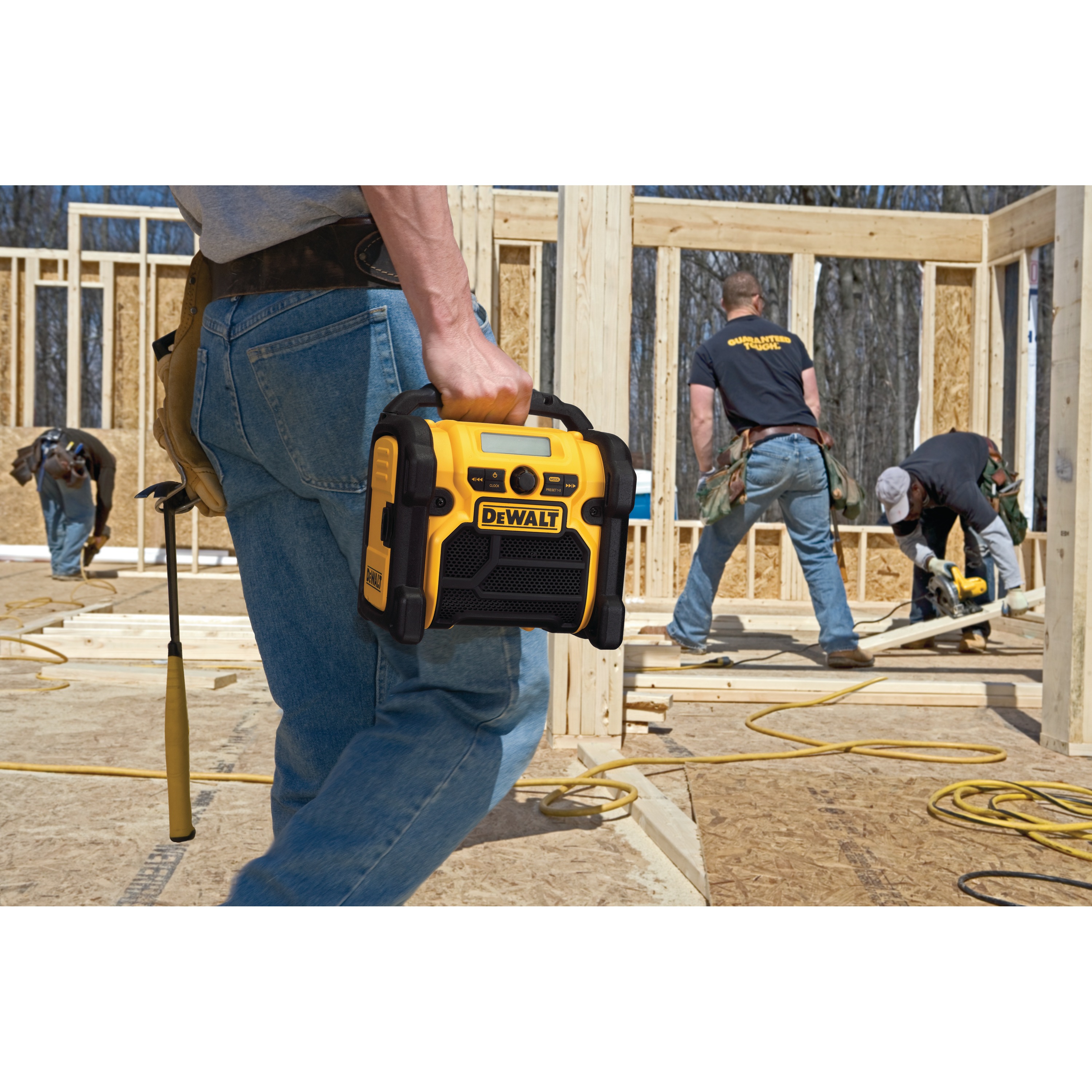 Compact Worksite Radio is being carried by a person to optimize user's productivity.