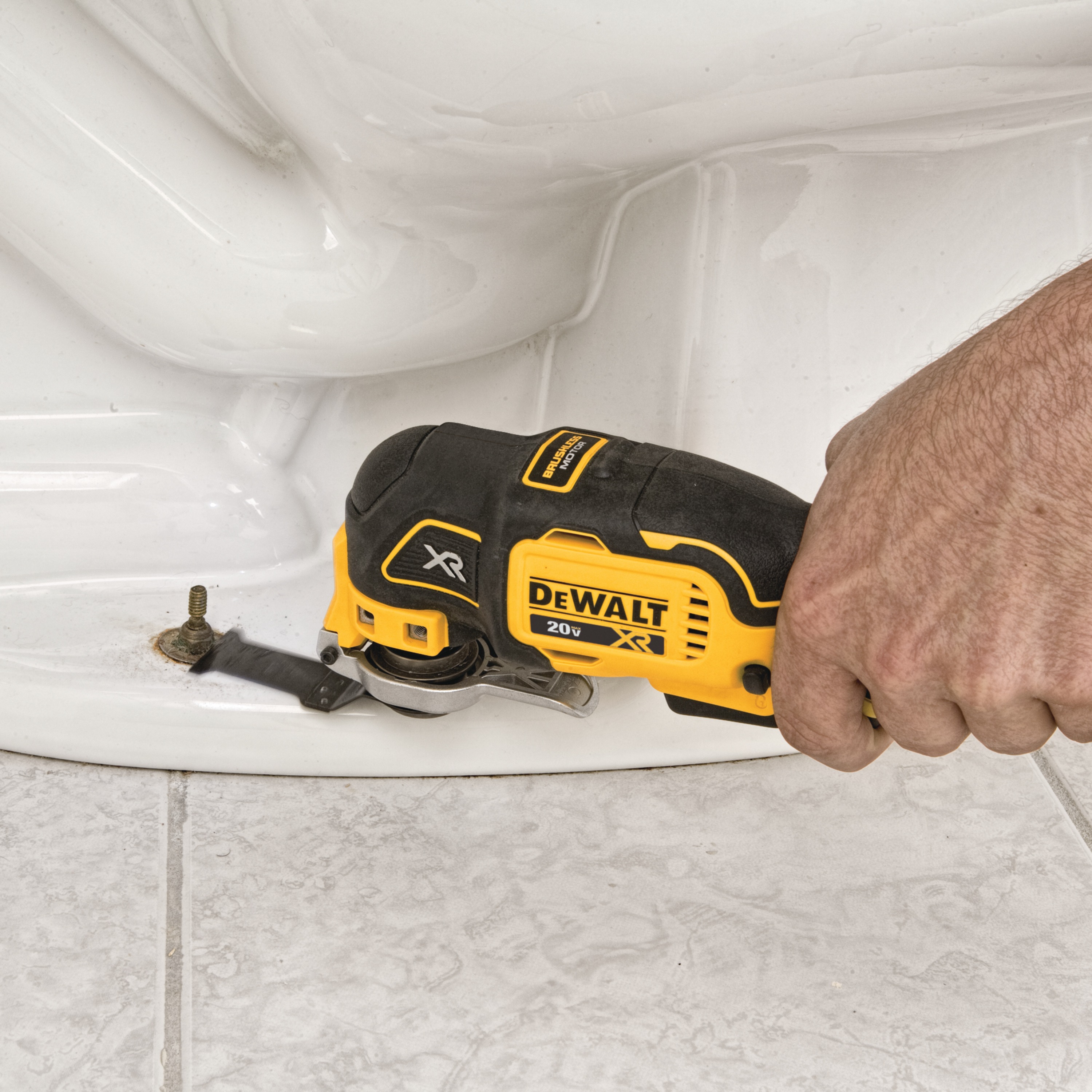 XR Cordless Oscillating Multi Tool being used to cut hardened bolt from a toilet base