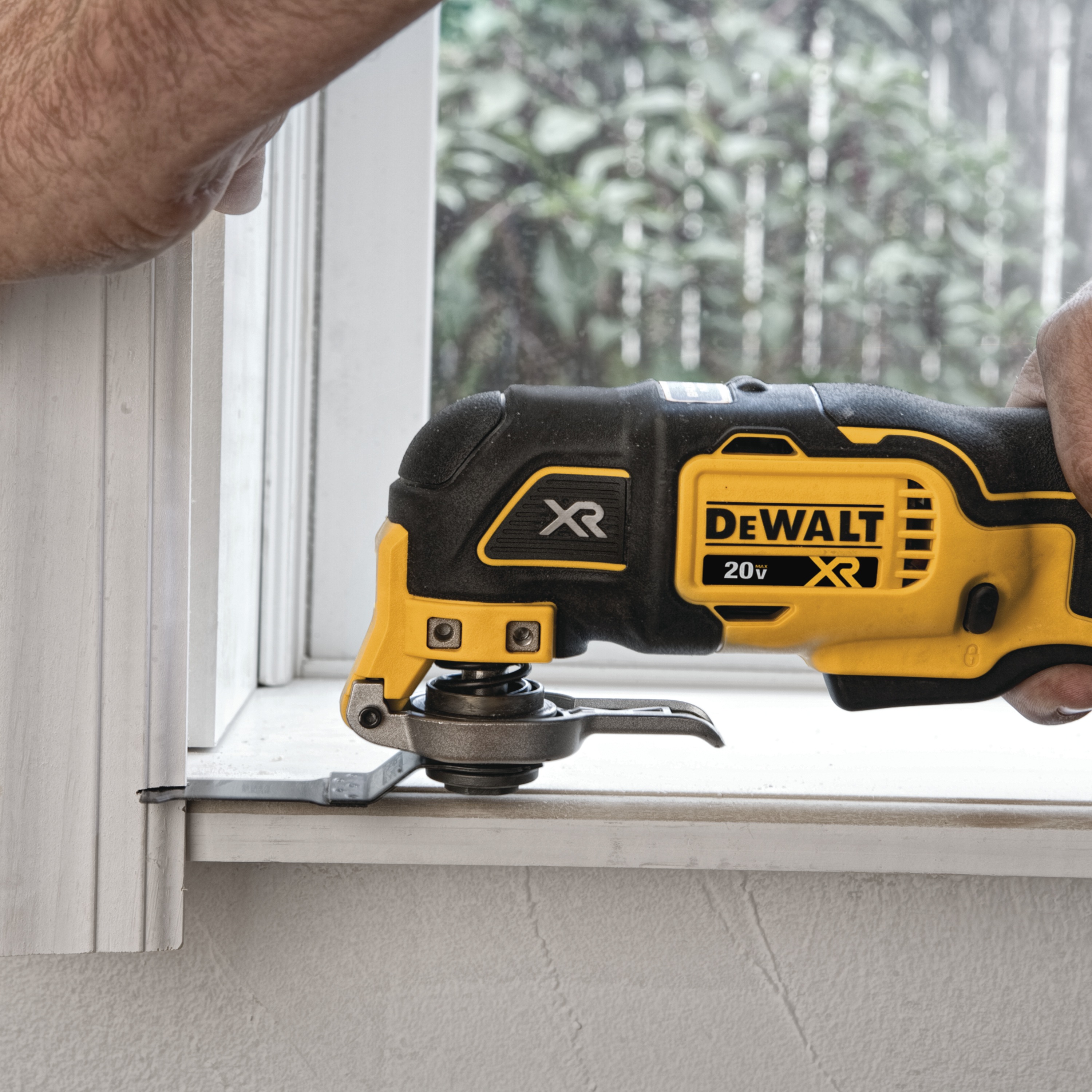 XR Cordless Oscillating Multi Tool being used by person to trim a wooden window frame 
