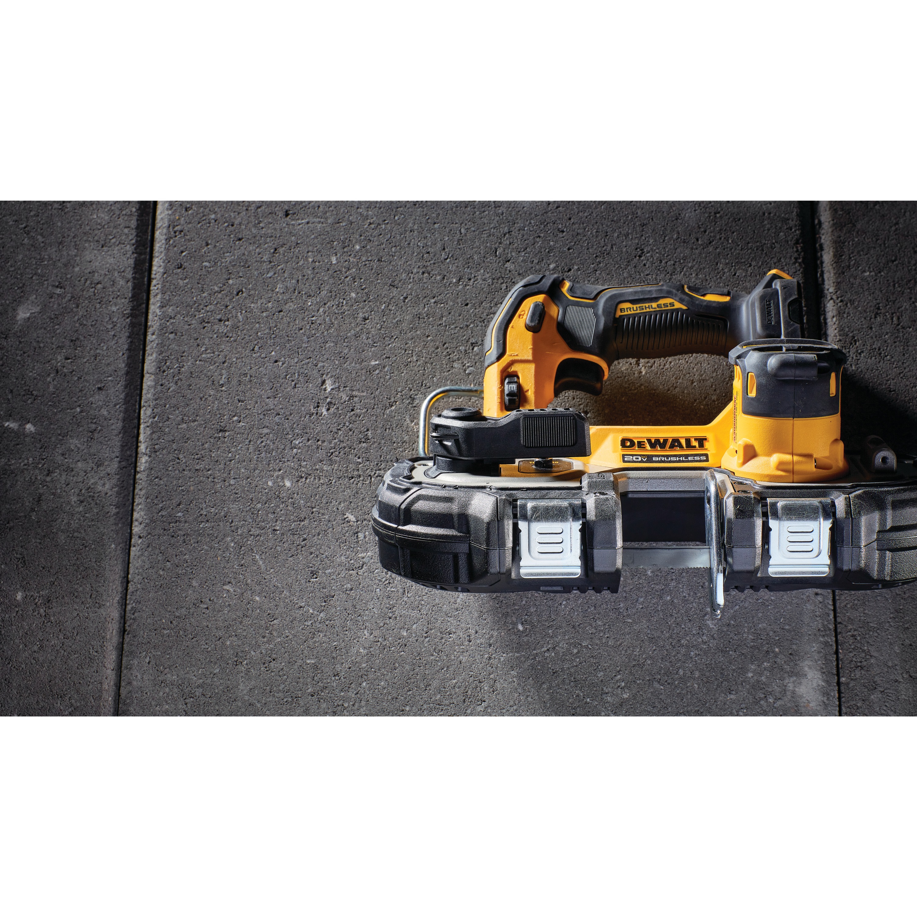 Overhead view of Brushless Cordless 1 and 3 quarters inch Compact Bandsaw placed on ground