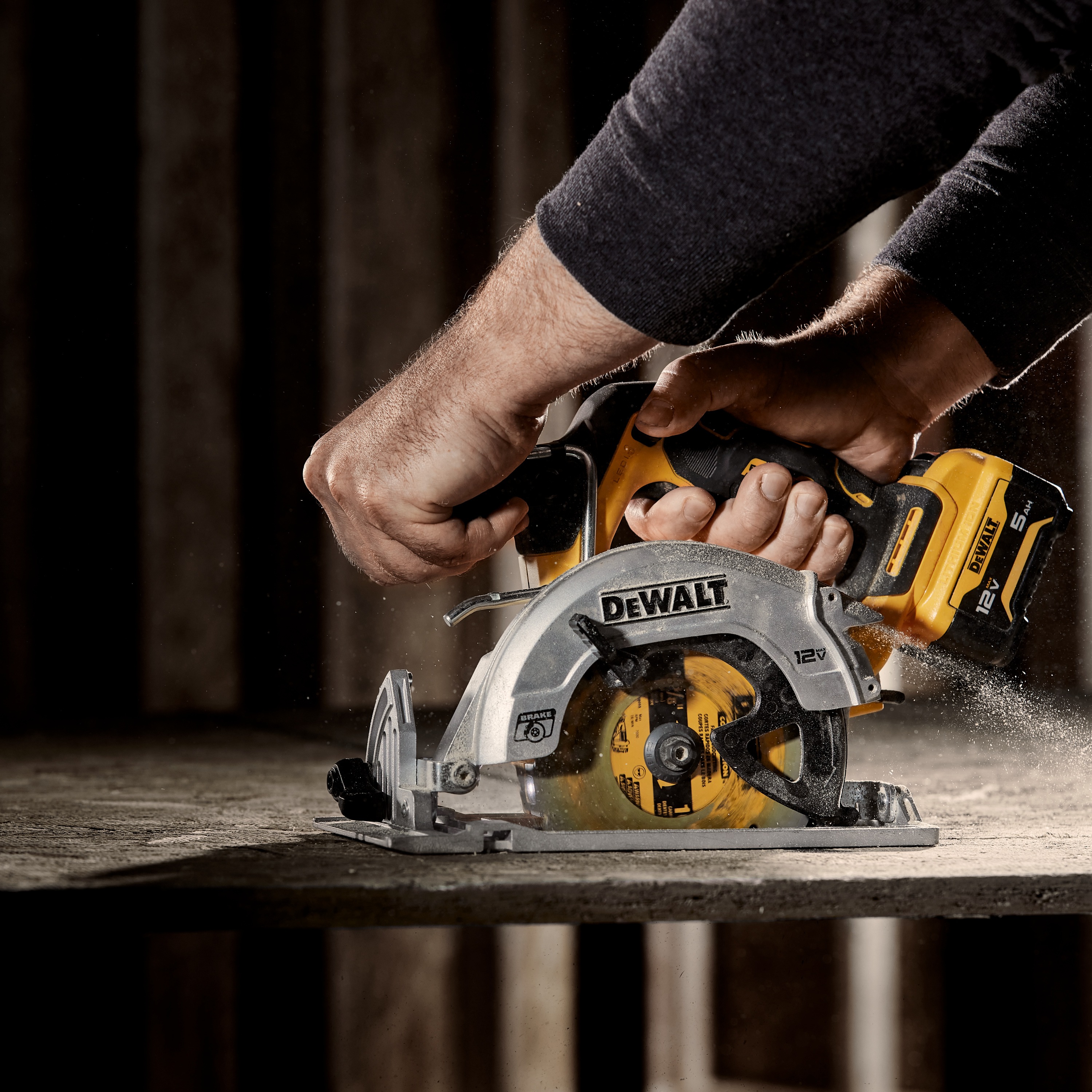 Xtreme 12 volt 5 and three eighths inch brushless cordless circular saw tool being used to cut wood.