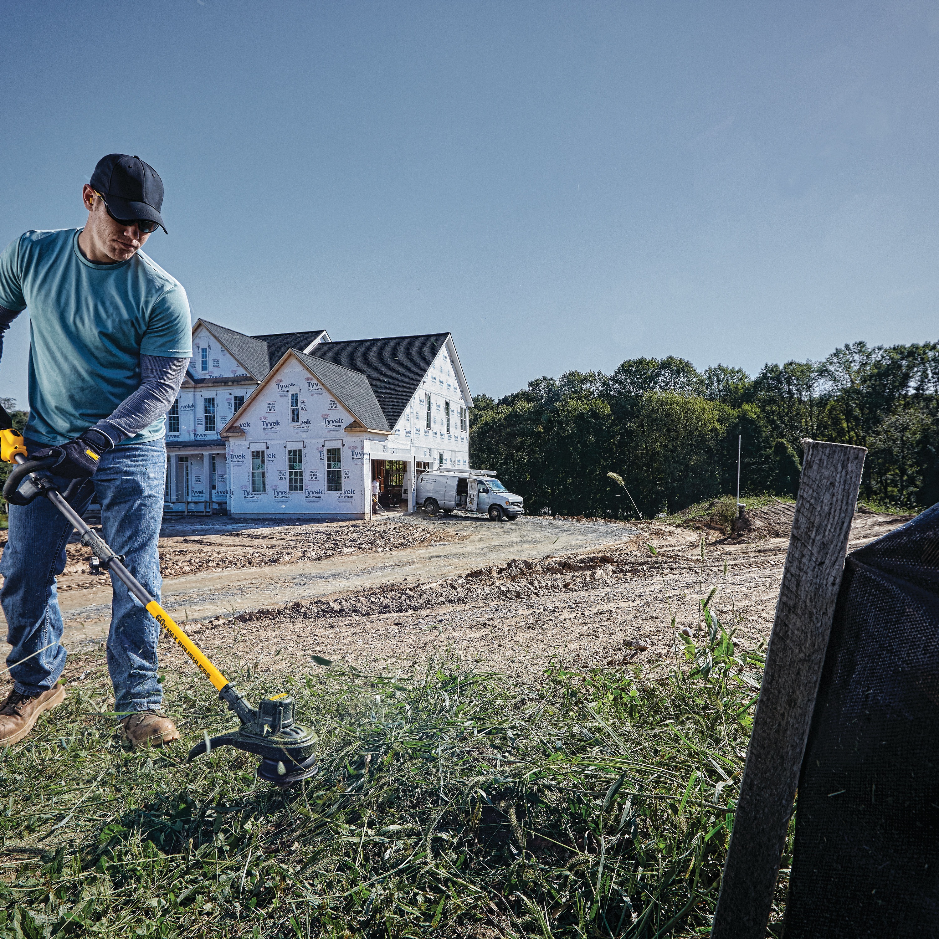 Cordless String Trimmer being used by a person.
