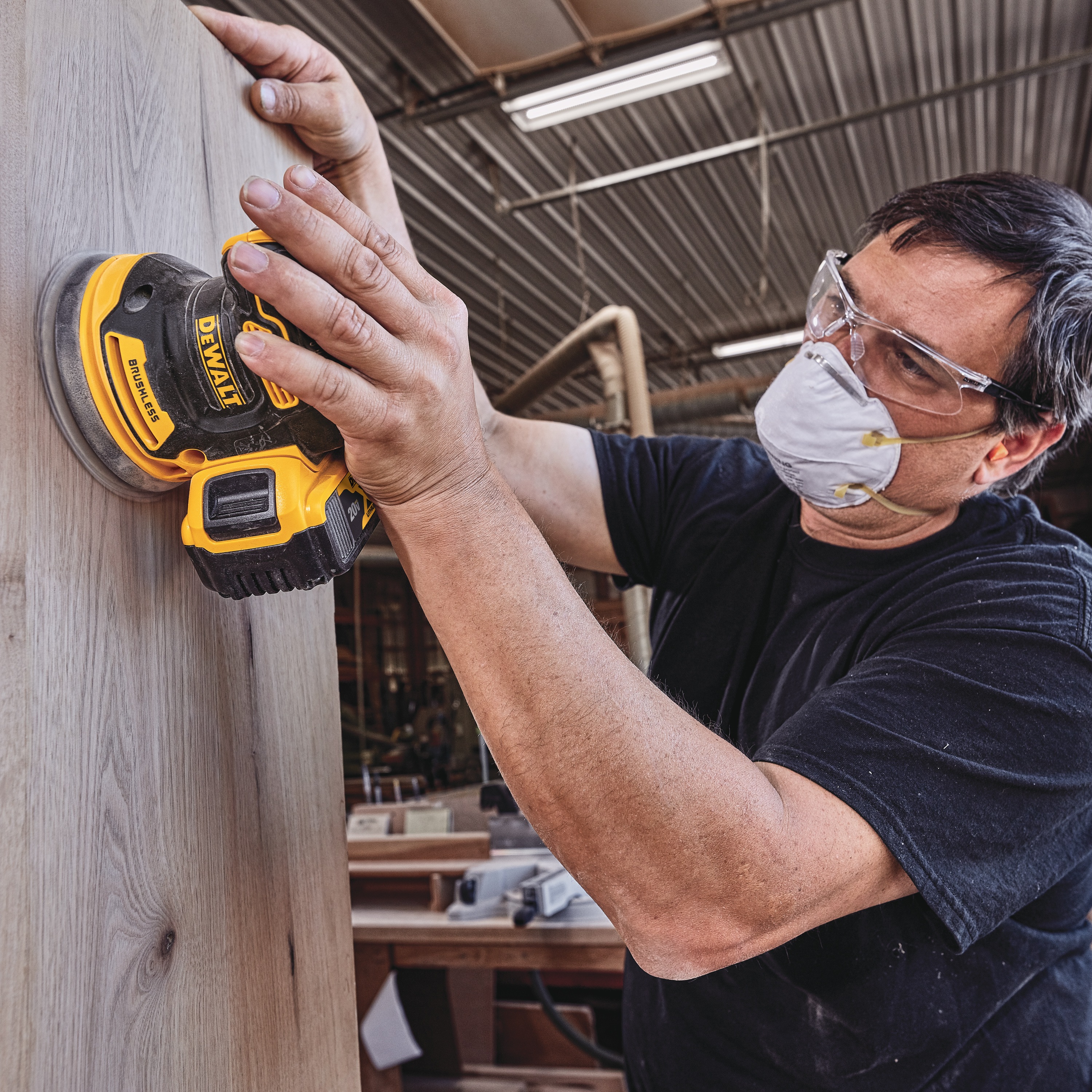 Brushless Cordless Variable Sheet Sander being used by a person.