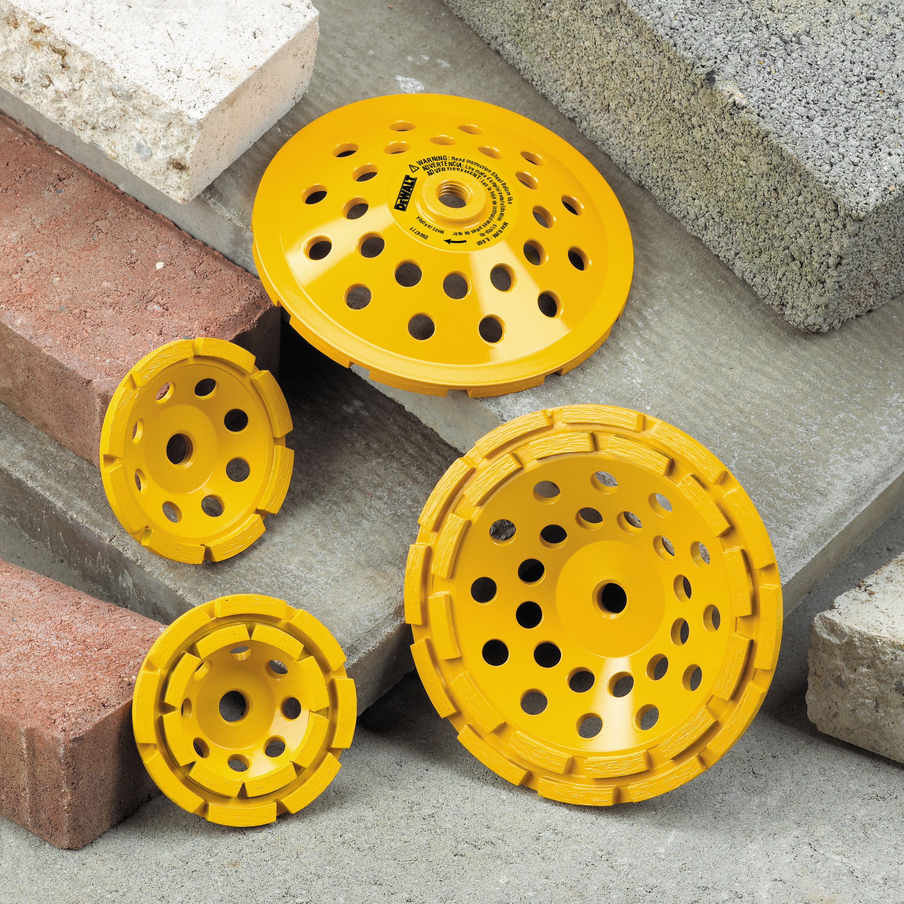 Surface Grinding Wheels placed on pile of concrete blocks.