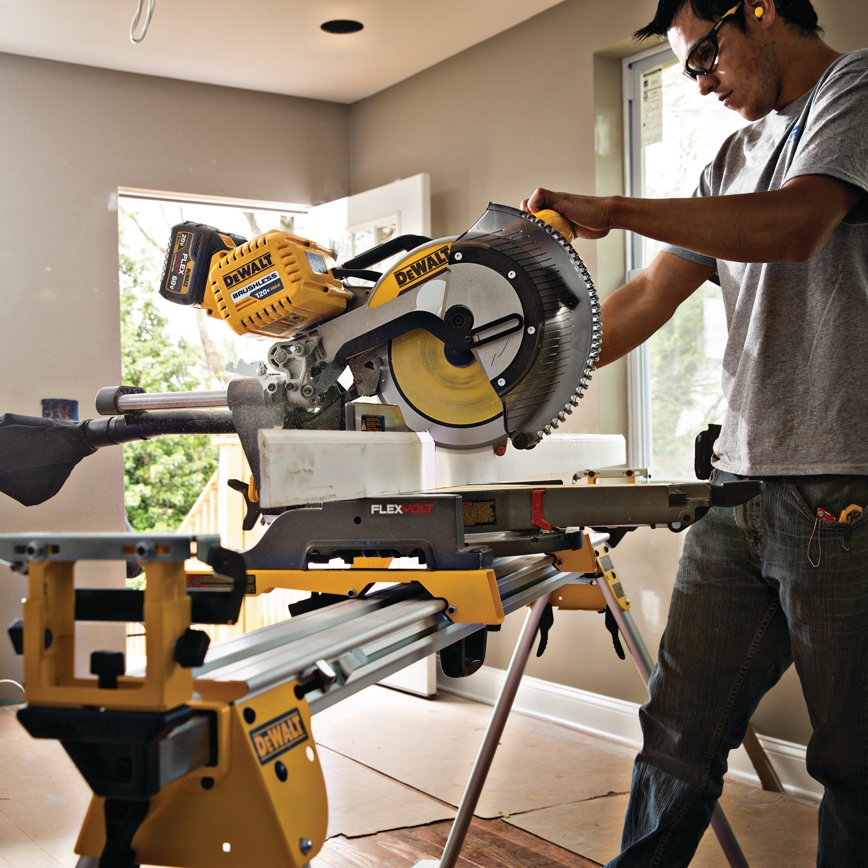 12 inch Miter saw blade being used by a person.