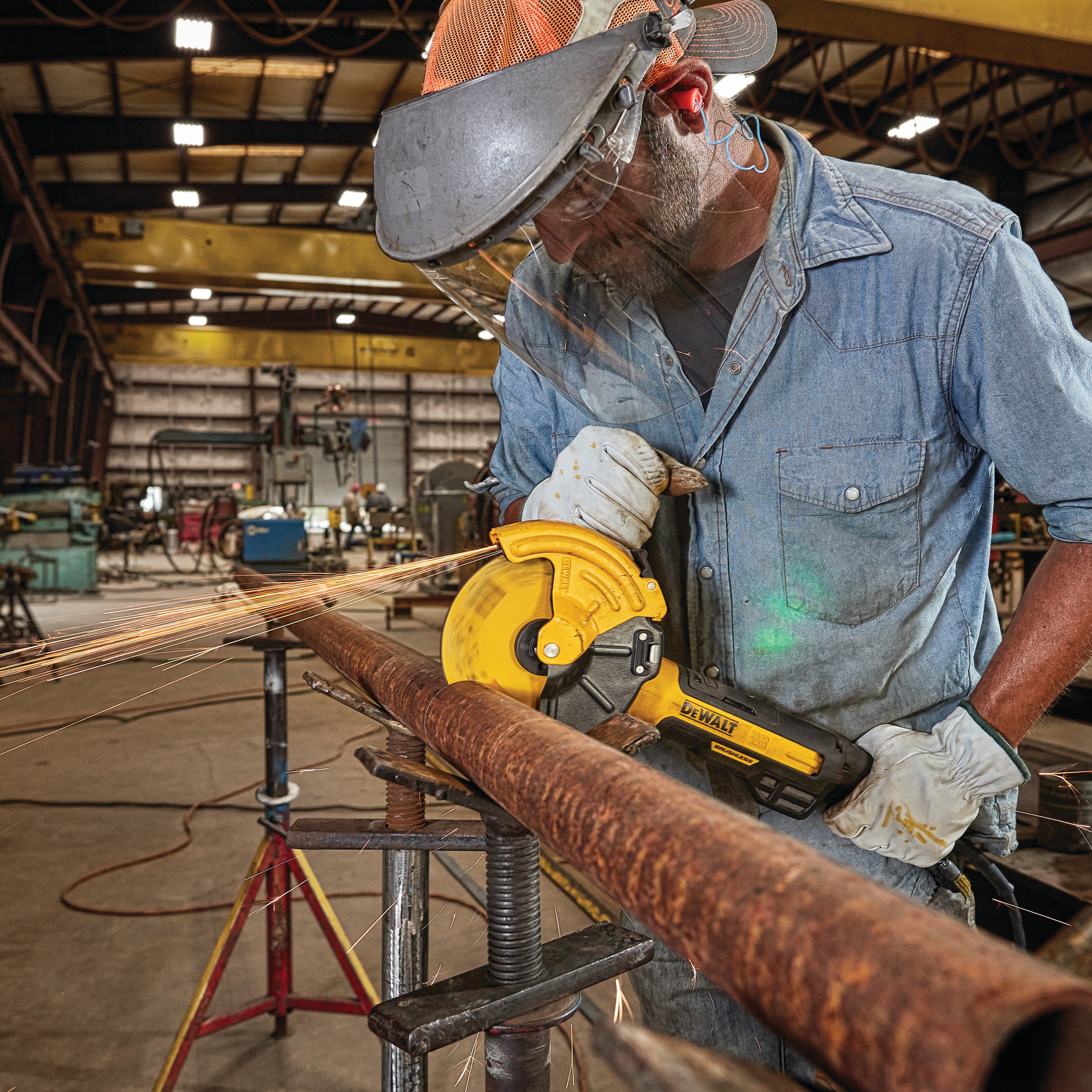 5 inch and 6 inch brushless small angle grinder with a rat tail, adjustable cut-off guard, kickback brake and nolock being used to grind on a metal pipe by a worker at a worksite.