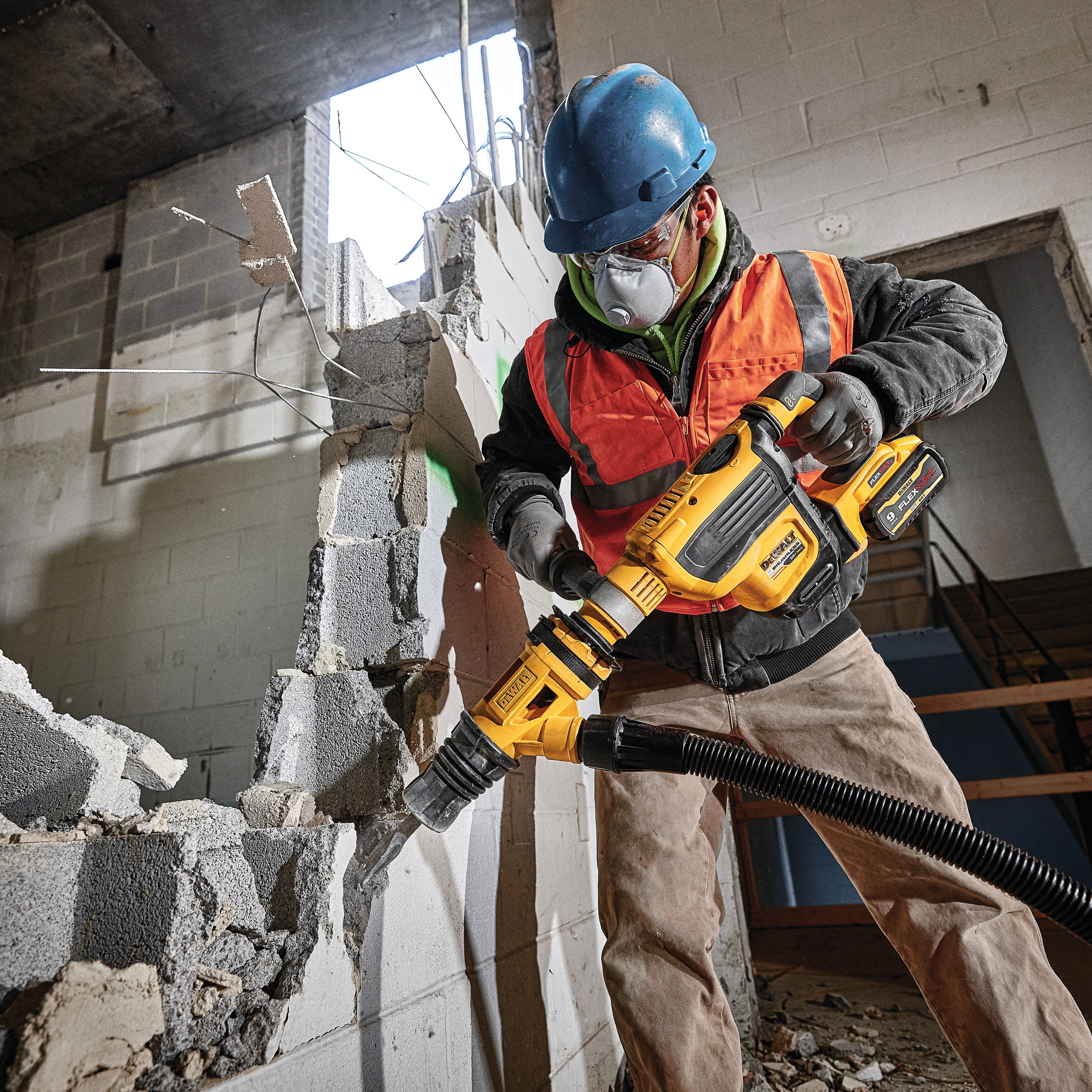 Close up of Demolition hammer dust shroud chiseling being used by a person to chisel. 