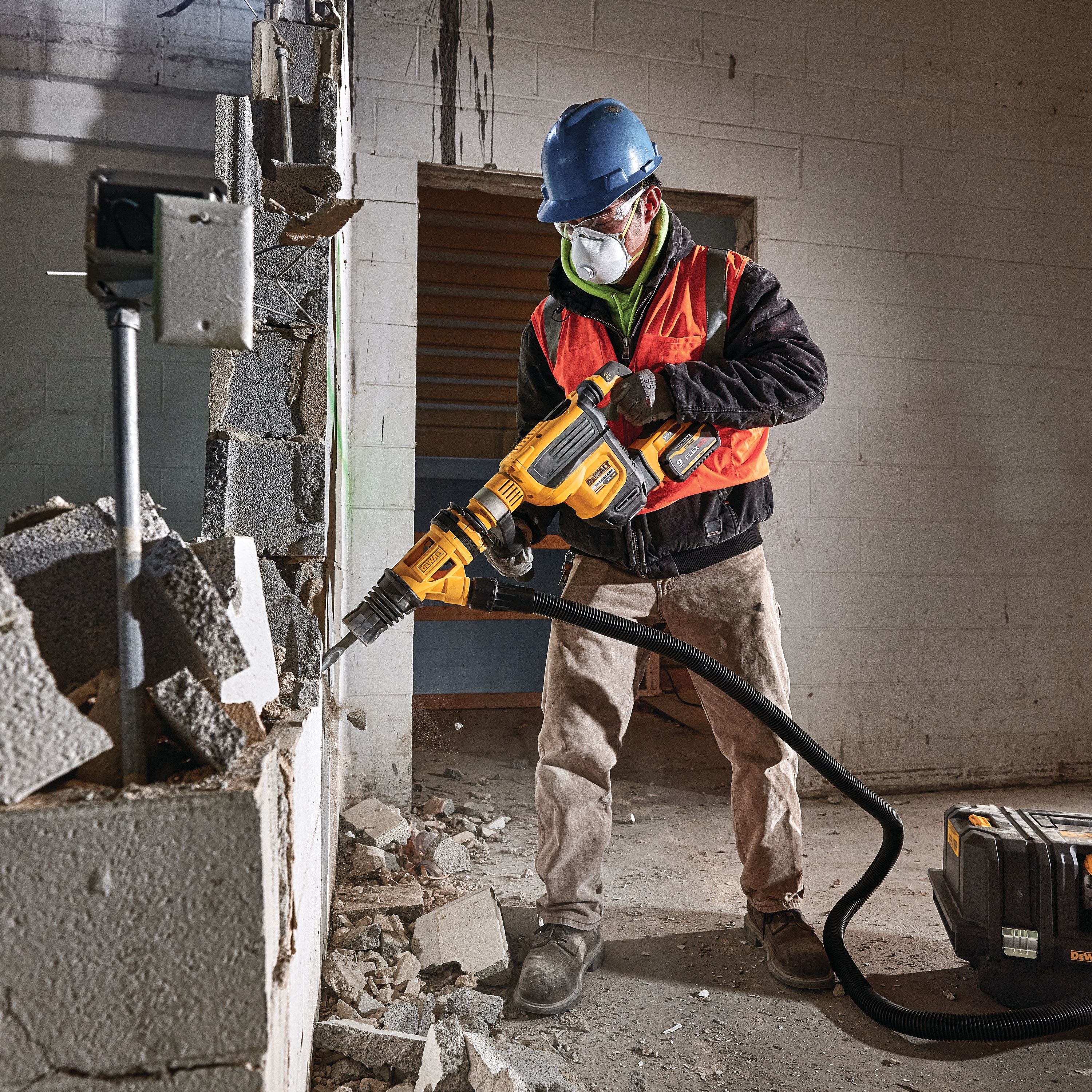 Demolition hammer dust shroud chiseling being used by a person to chisel. 