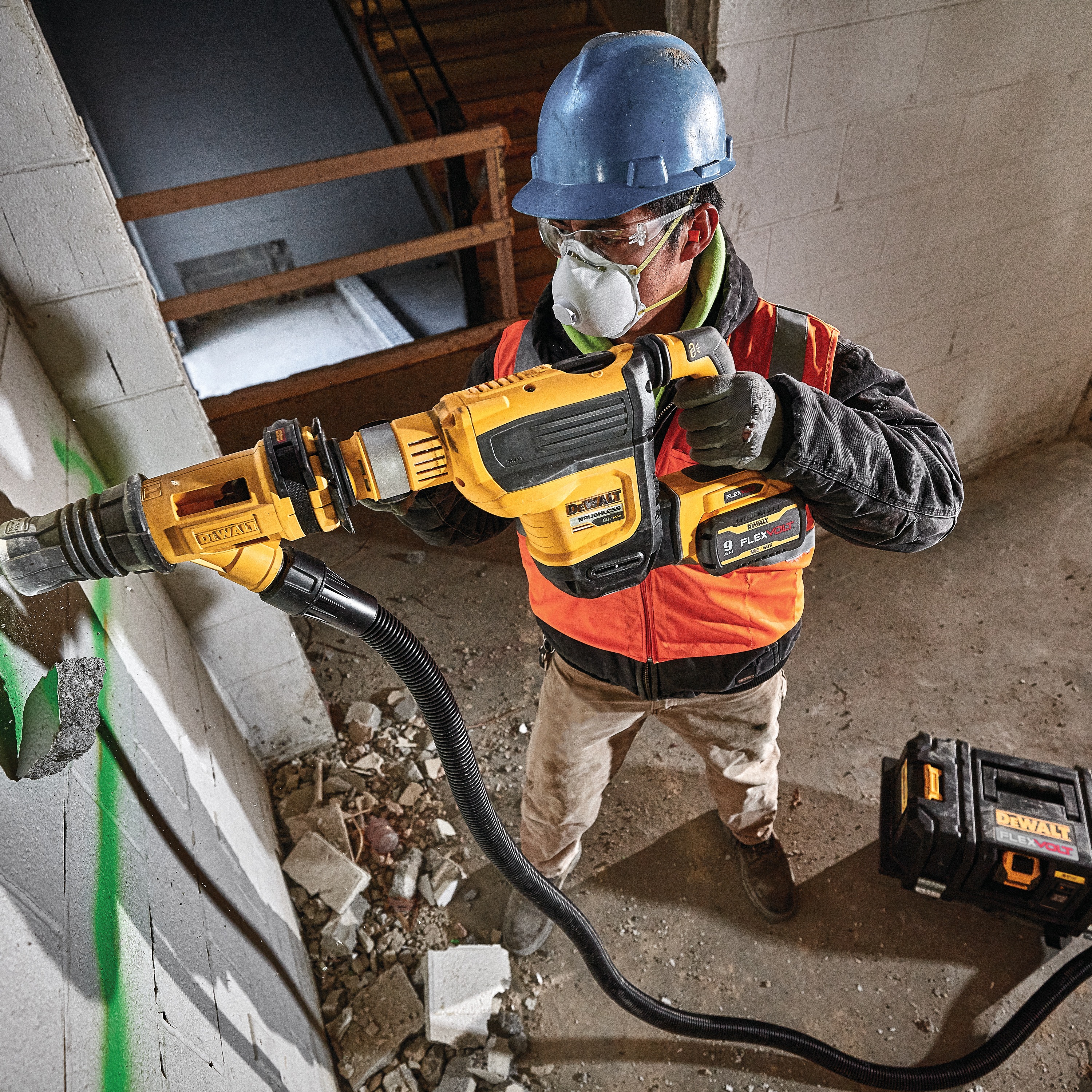 Overhead view of Demolition hammer dust shroud chiseling being used by a person to chisel. 