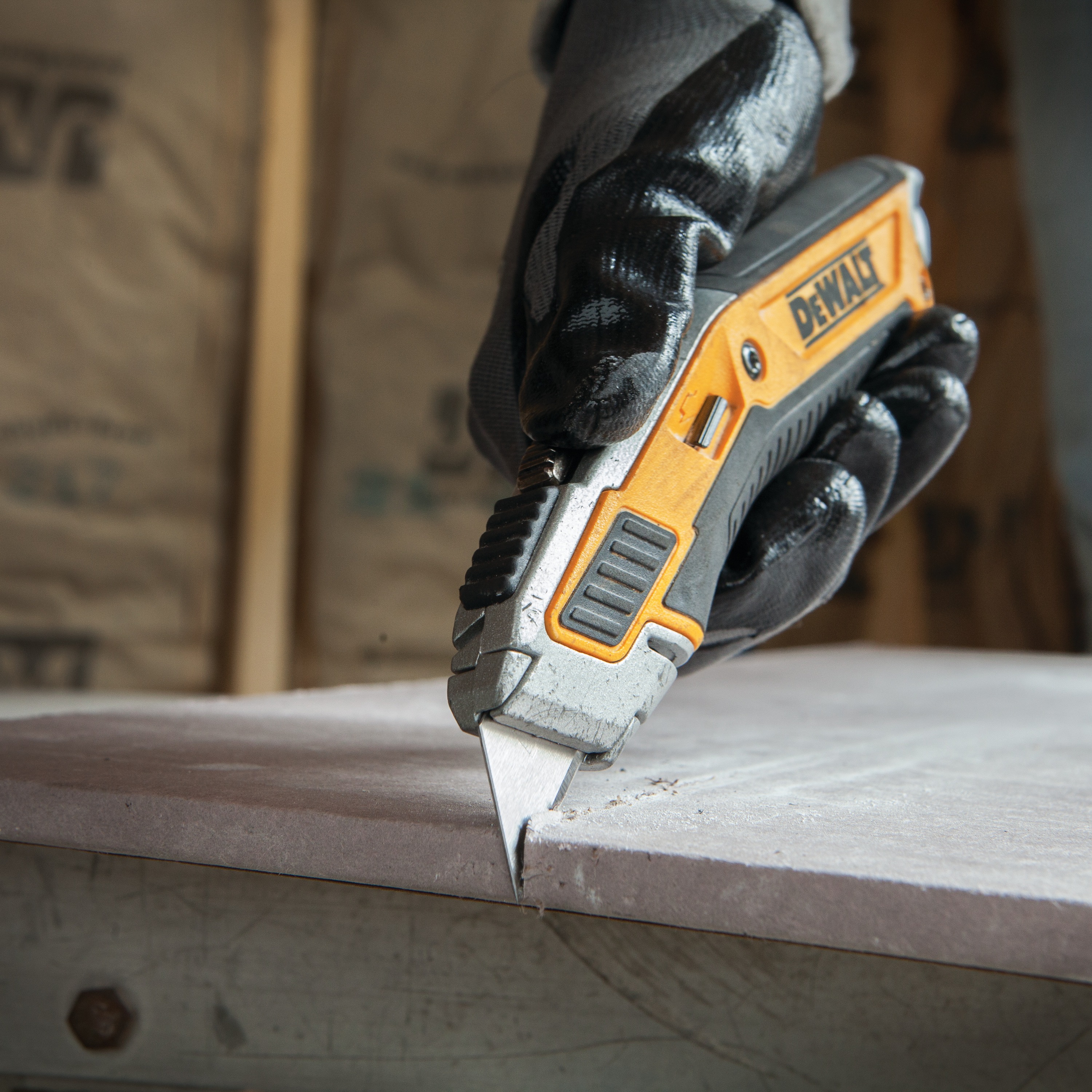 Close up of Premium retractable utility knife cutting hard concrete.