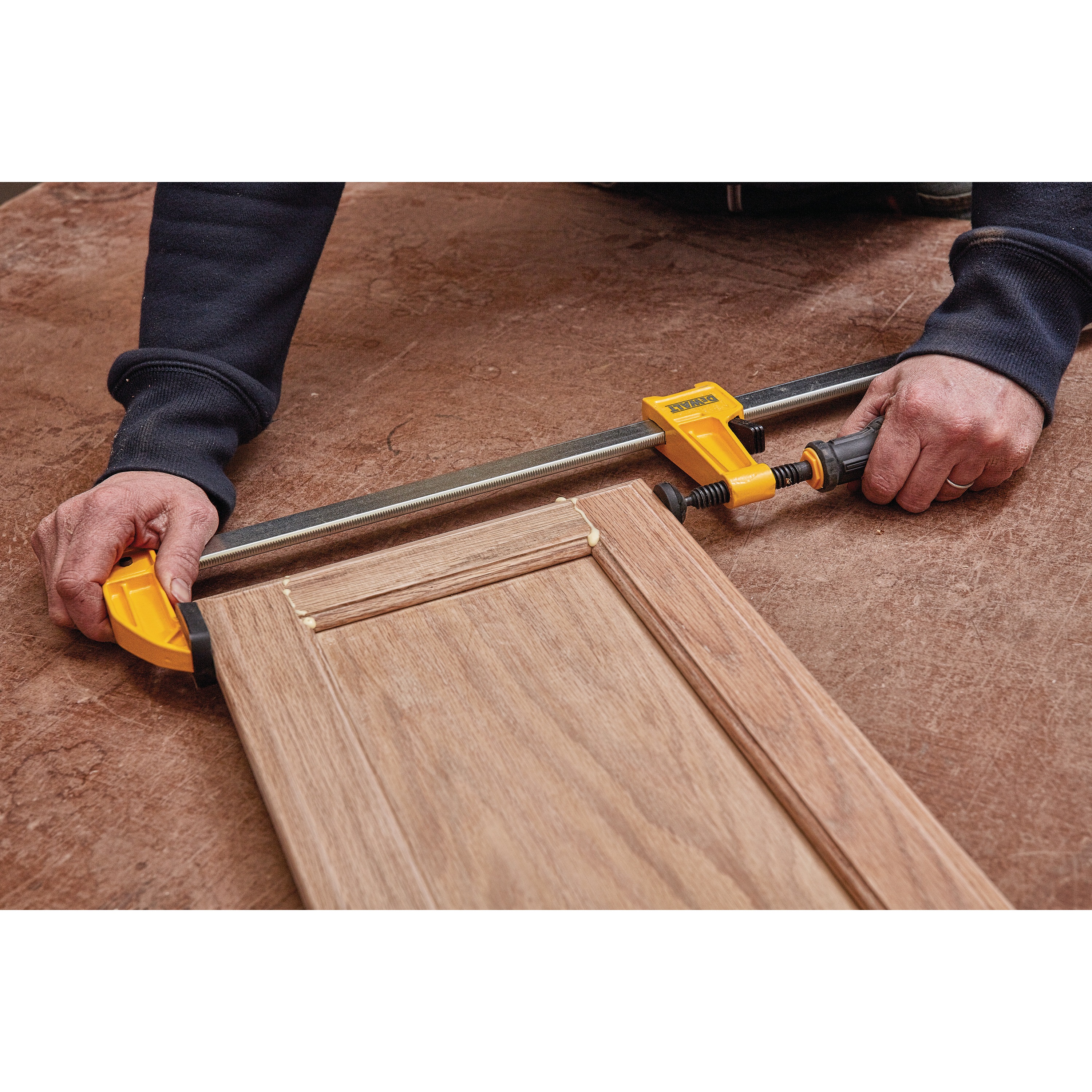 6 inch Heavy Duty Bar Clamp being used on wooden structures by a person.