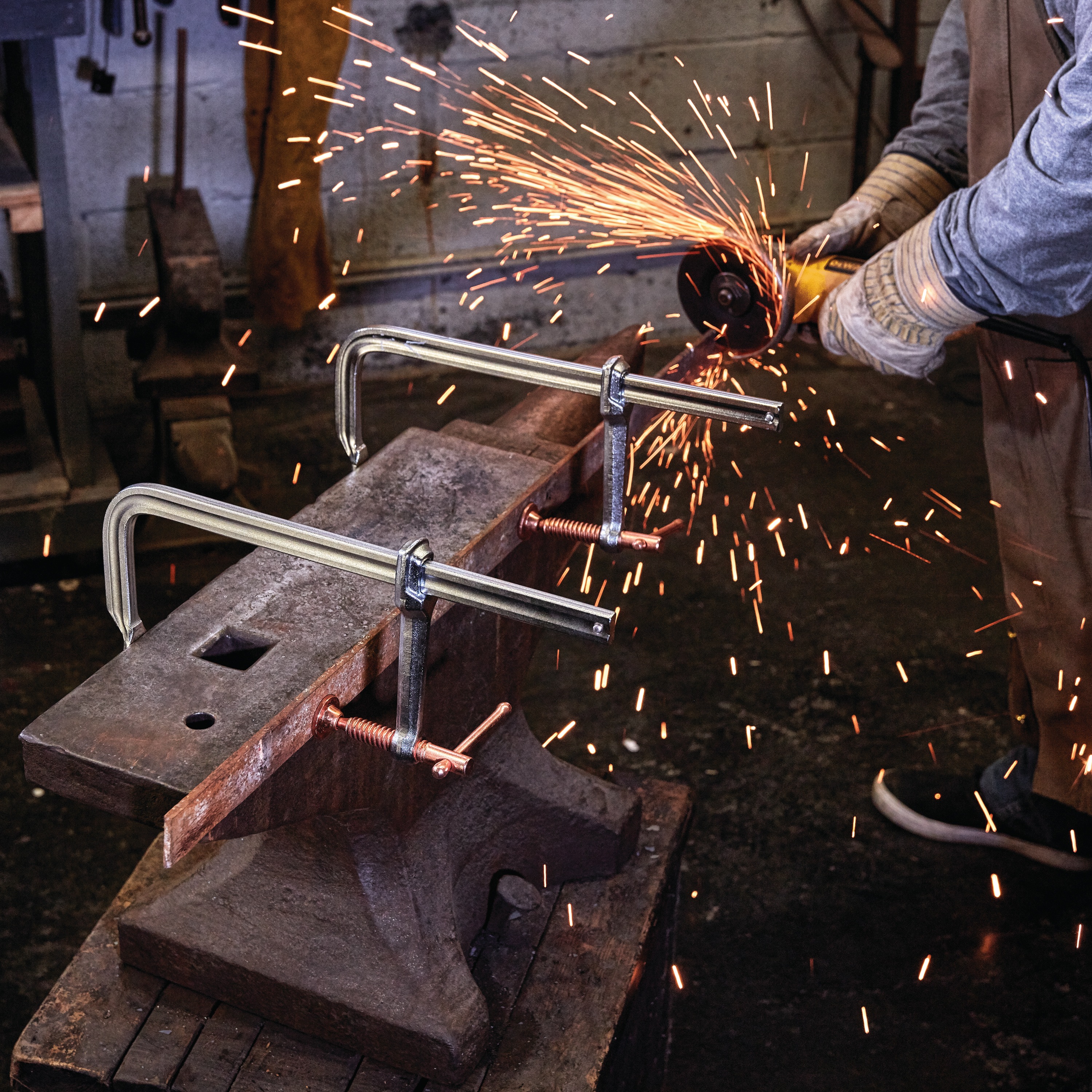 12 inch Metalworking bar Clamp being used by a person in a workshop.