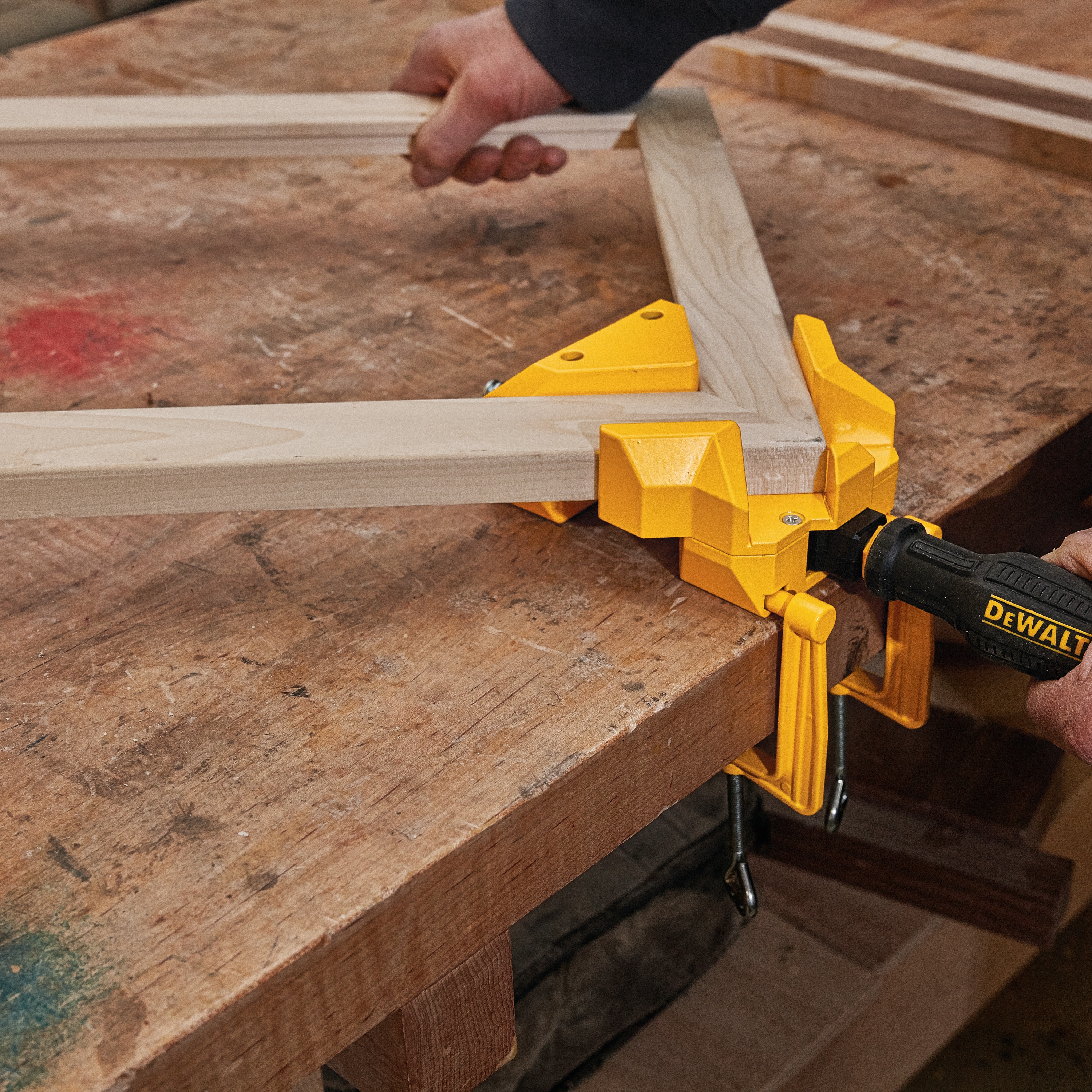 90 Degree Angle Clamp being used by a person on a wooden frame.