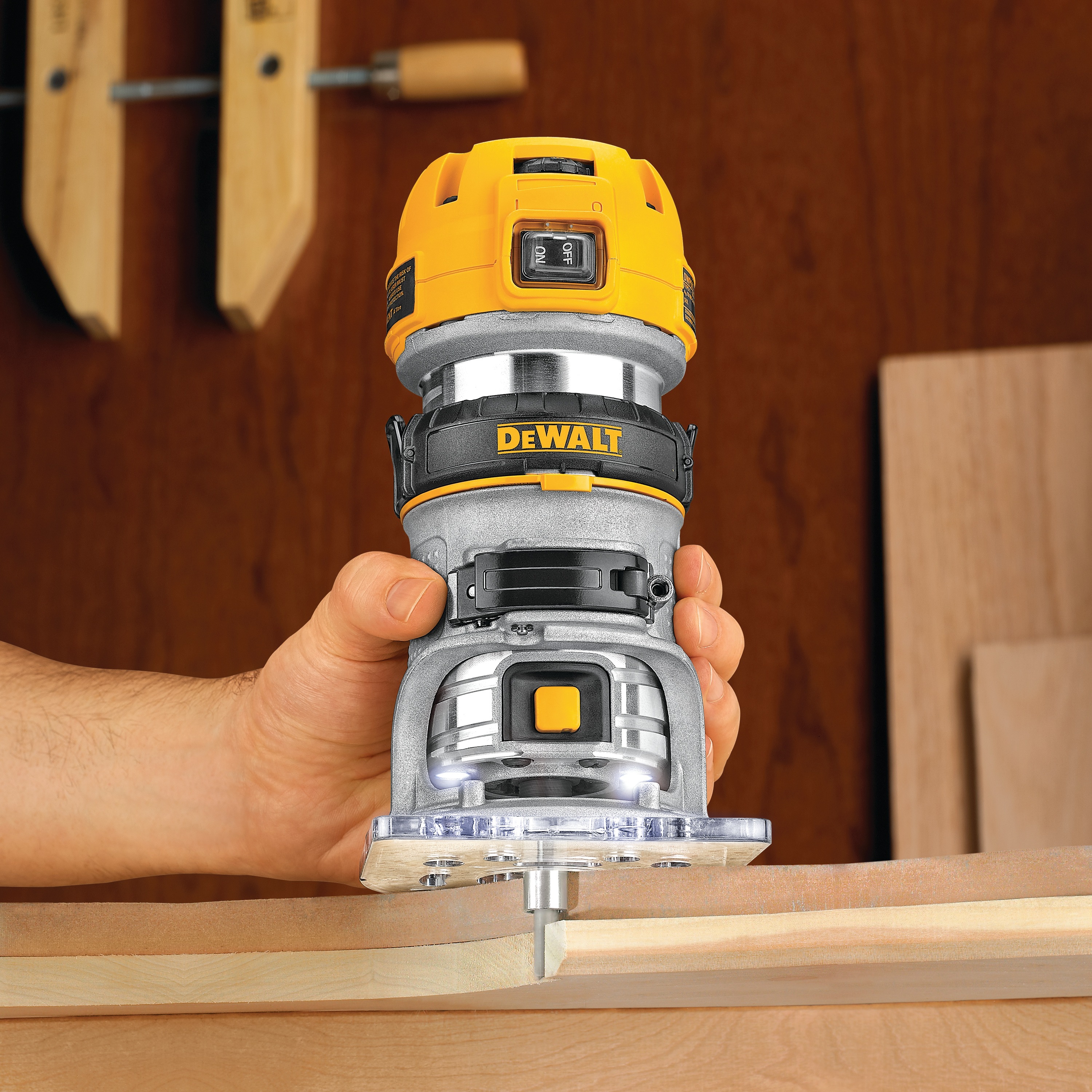 Max torque variable speed compact router being used to cut wood.