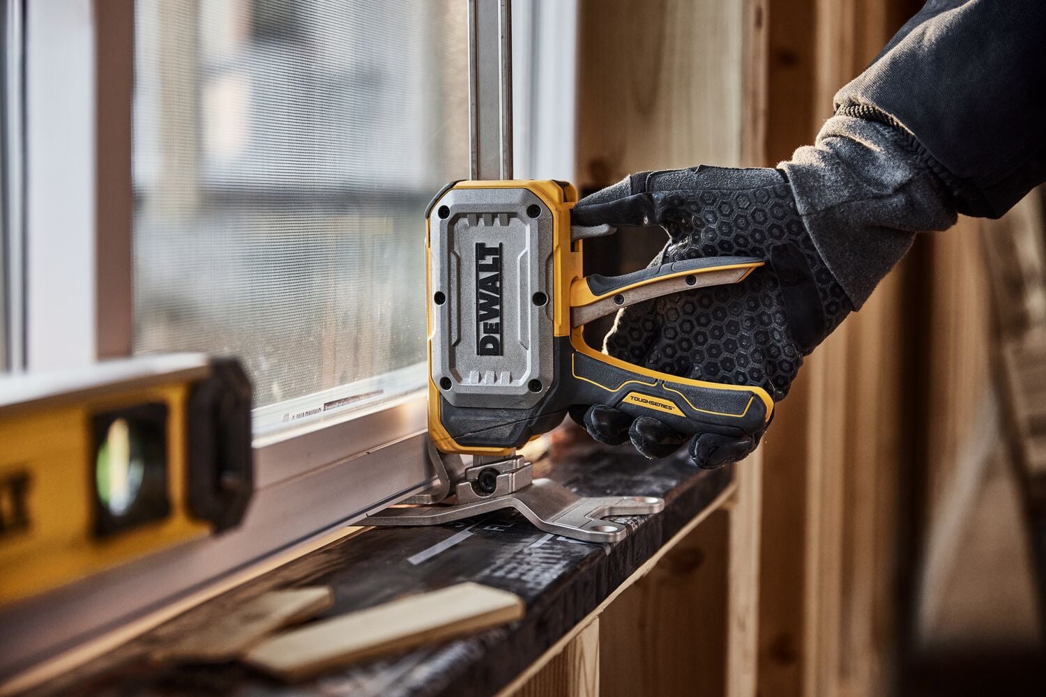 Worker leveling a window with DEWALT(R) TOUGHSERIES(TM) CONSTRUCTION JACK 