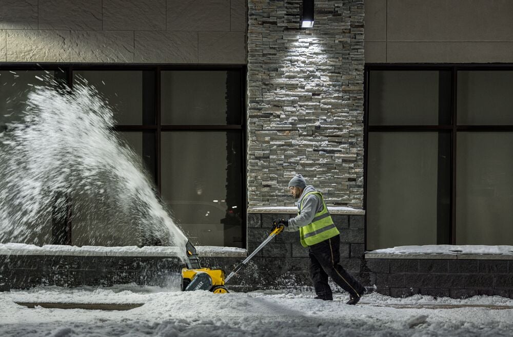 DEWALT Single-Stage Snow Blower application image person blowing snow side view