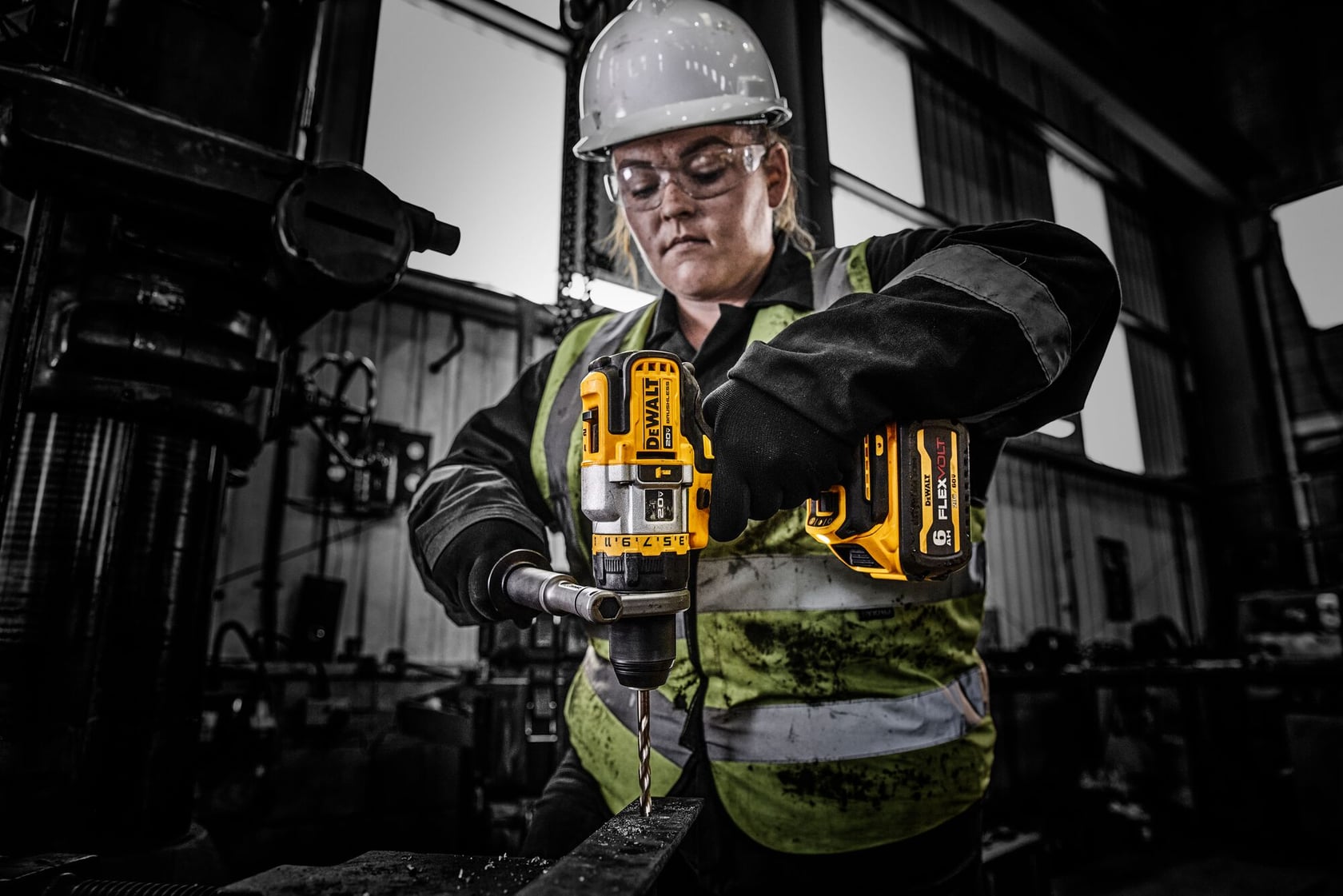 Close up of worker using a hammer drill in a workshop 