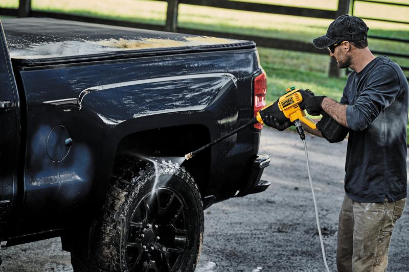 Cordless Power Cleaner is being used by a person to clean tire.