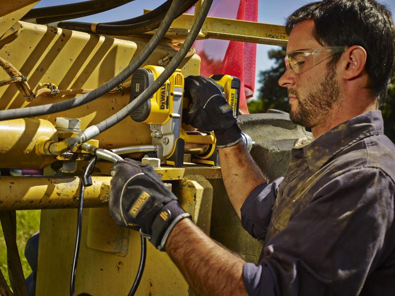 Grease gun being used by a person outdoors