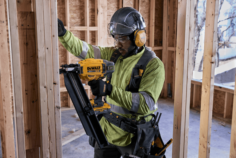 user working with nailer on commercial jobsite 