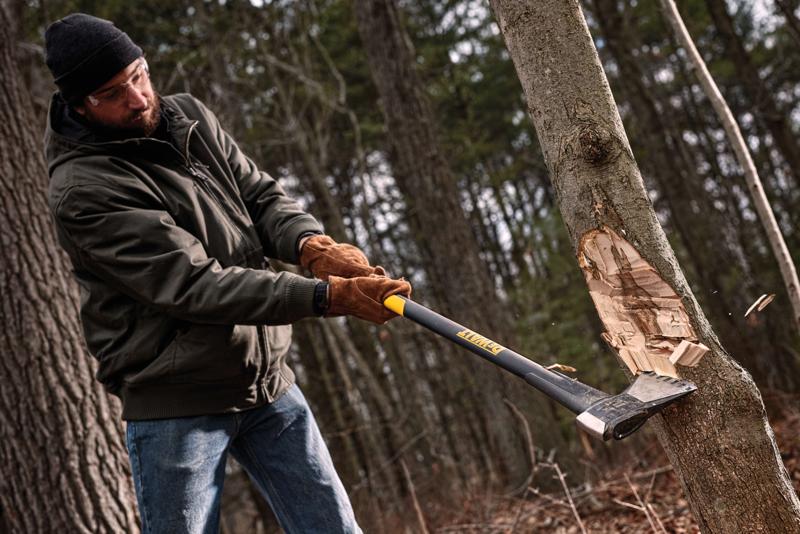 3.5 pound EXOCORE Single Bit Axe being used by a person to cut a tree stem.