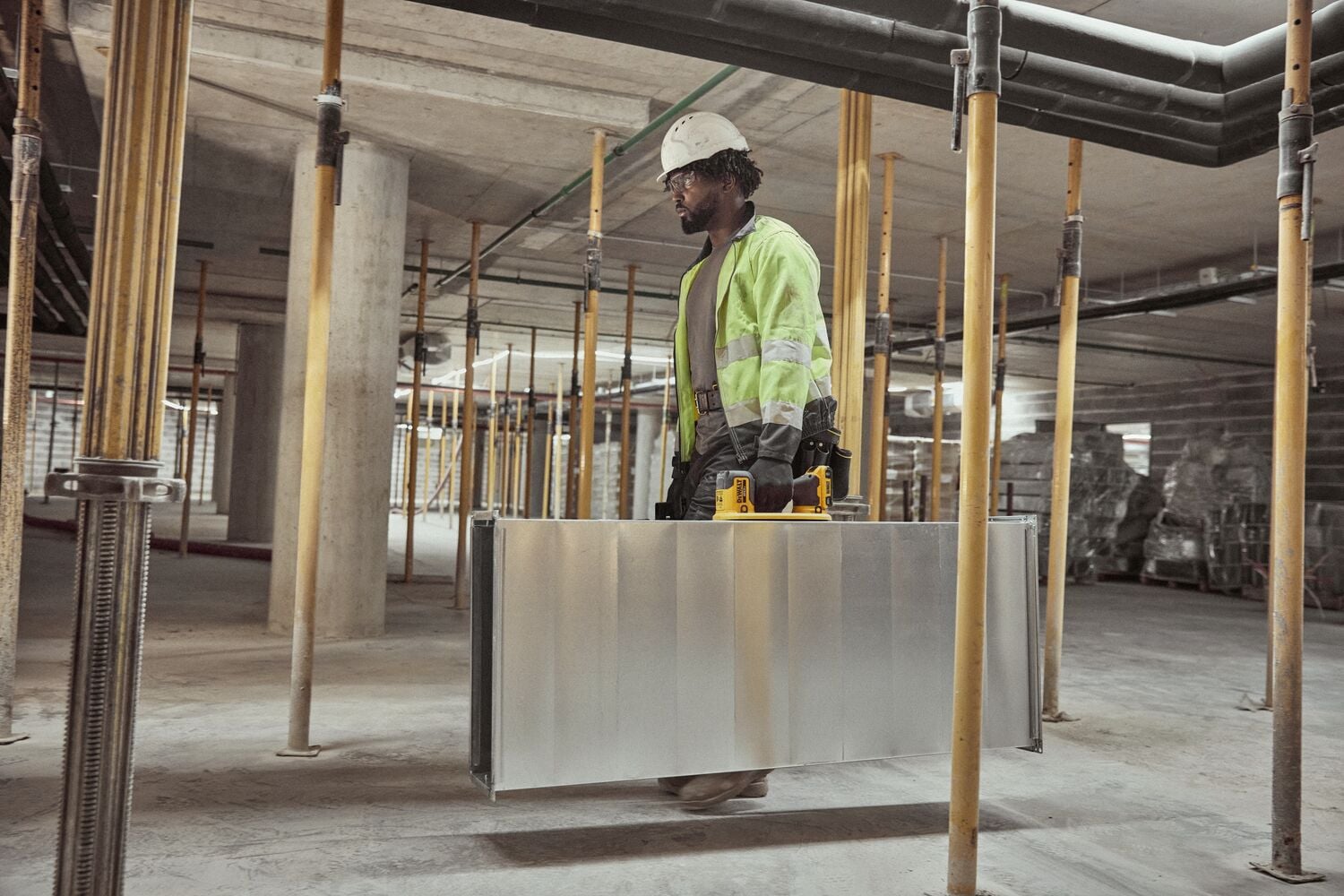 User lifting HVAC duck with DEWALT 20V MAX Grabo Lifter