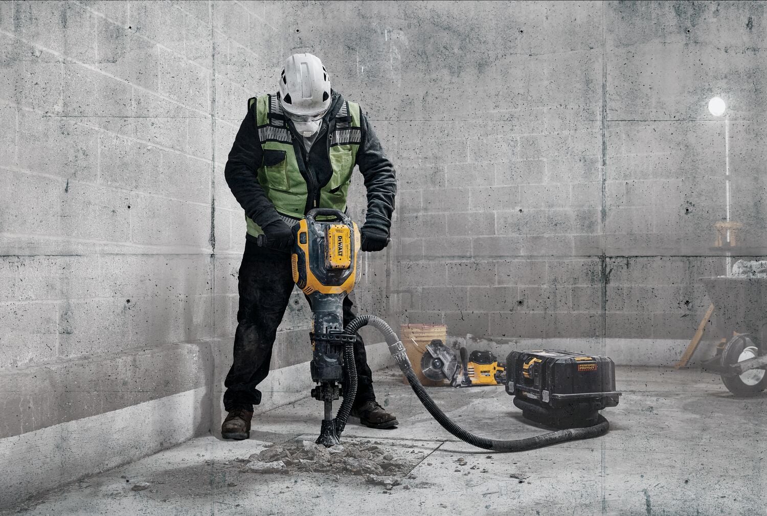 Man using 60 volt Max 38 pounds. 1-1/8 inch Hex Demolition hammer on concrete slab