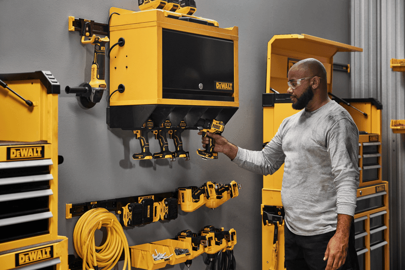 A Person Grabbing a Power Tool out of a Power Tool Holster 