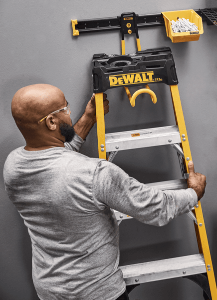 Person Taking a Ladder off of a Ladder Hook