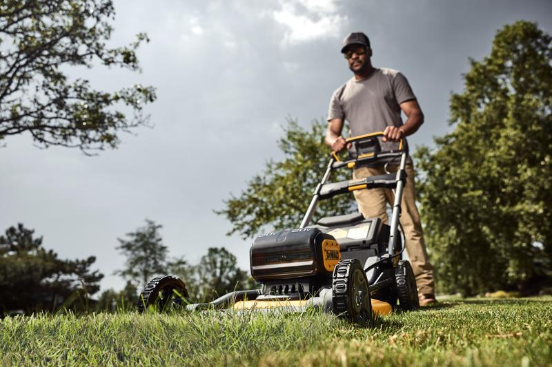 Landscaper pushing DEWALT XR Push Mower on lawn