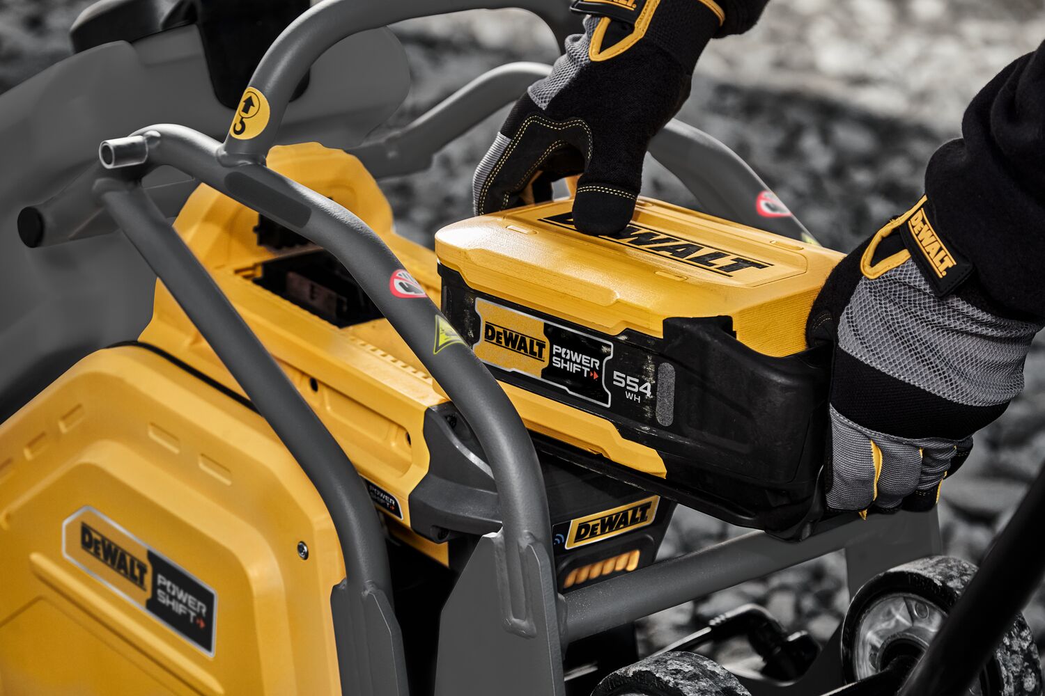 Man inserting battery into plate compactor